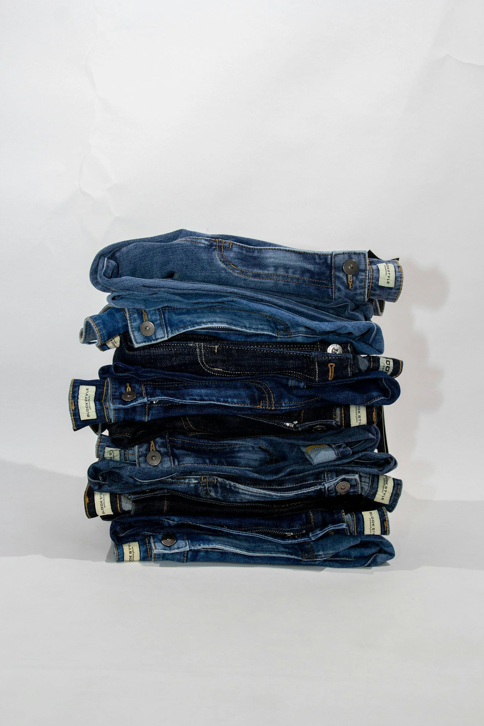 Jean folded and stacked. This represents how women with body image issues can in Salt Lake City can make peace with their clothing size.