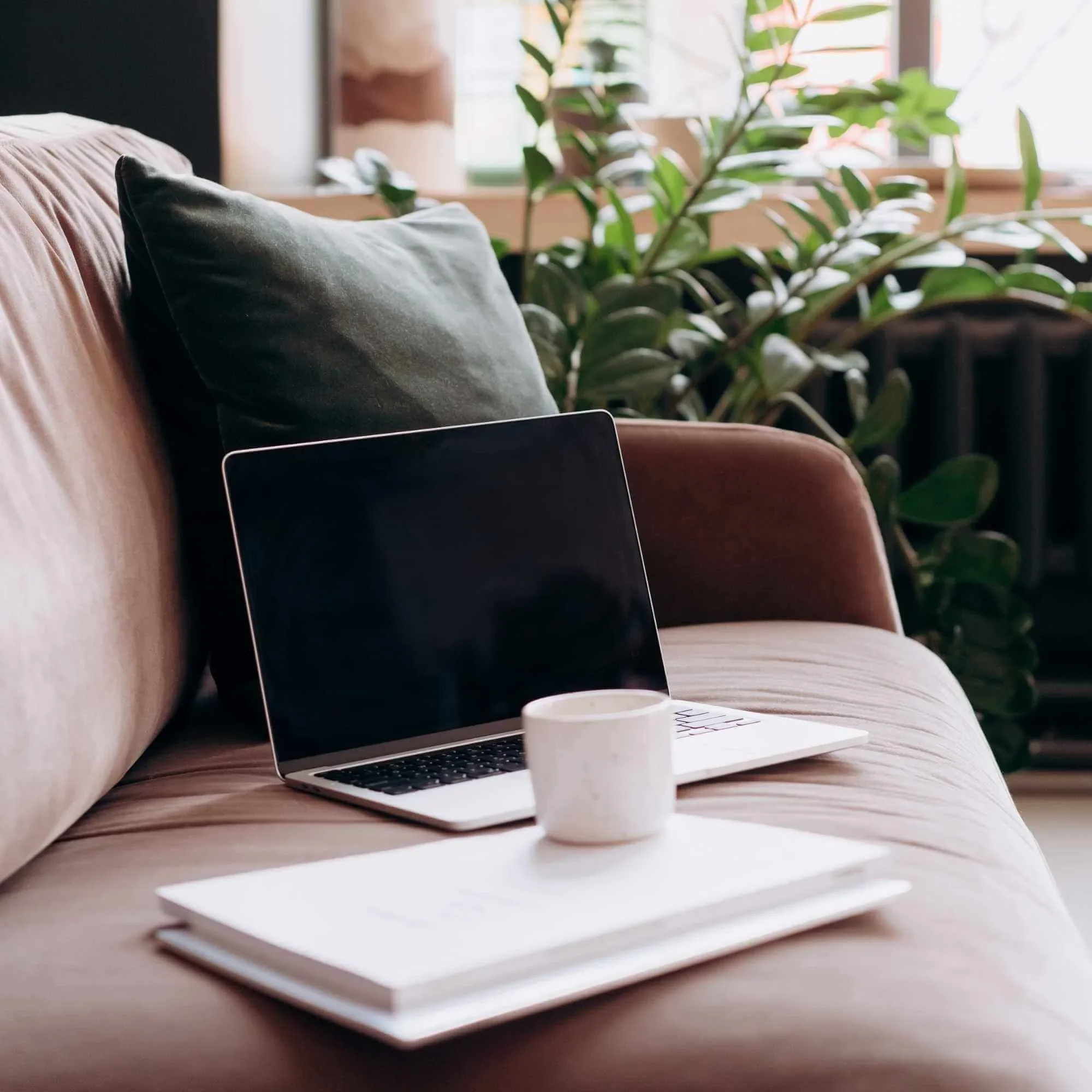 Laptop sitting on a couch representing online therapy for women Salt Lake City, Utah