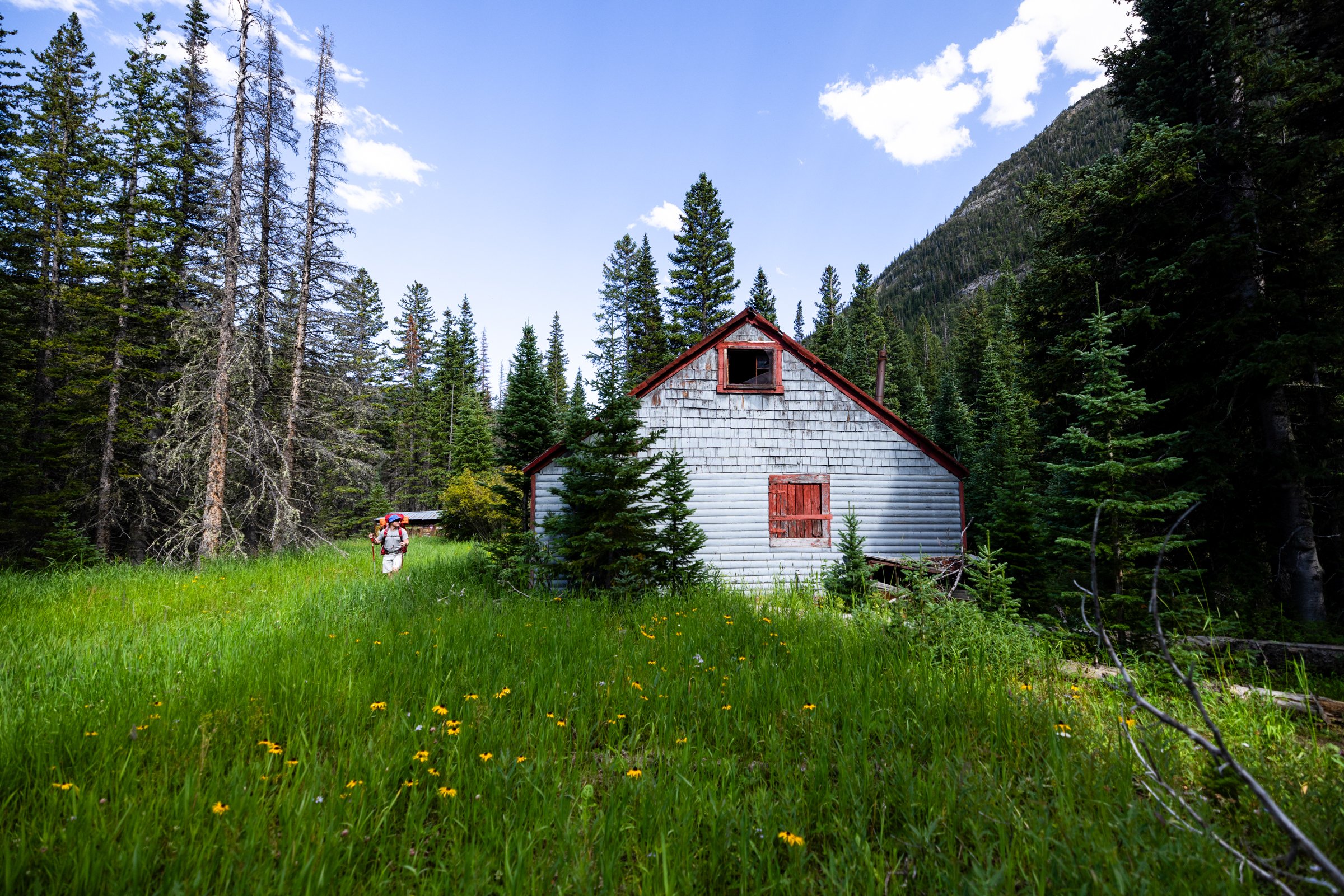 A Visit of the East Portal Camp Cabins, Tolland, 2023. Along a popular hiking trail lies a colorfully painted cabin in a lush meadow near the East Portal of the Moffat Tunnel.