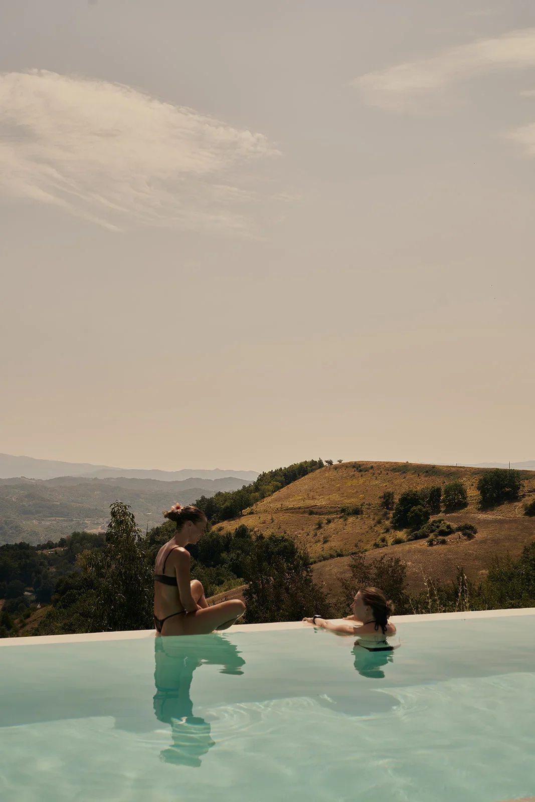 Girls-on-poolside-Villa-Asti.webp