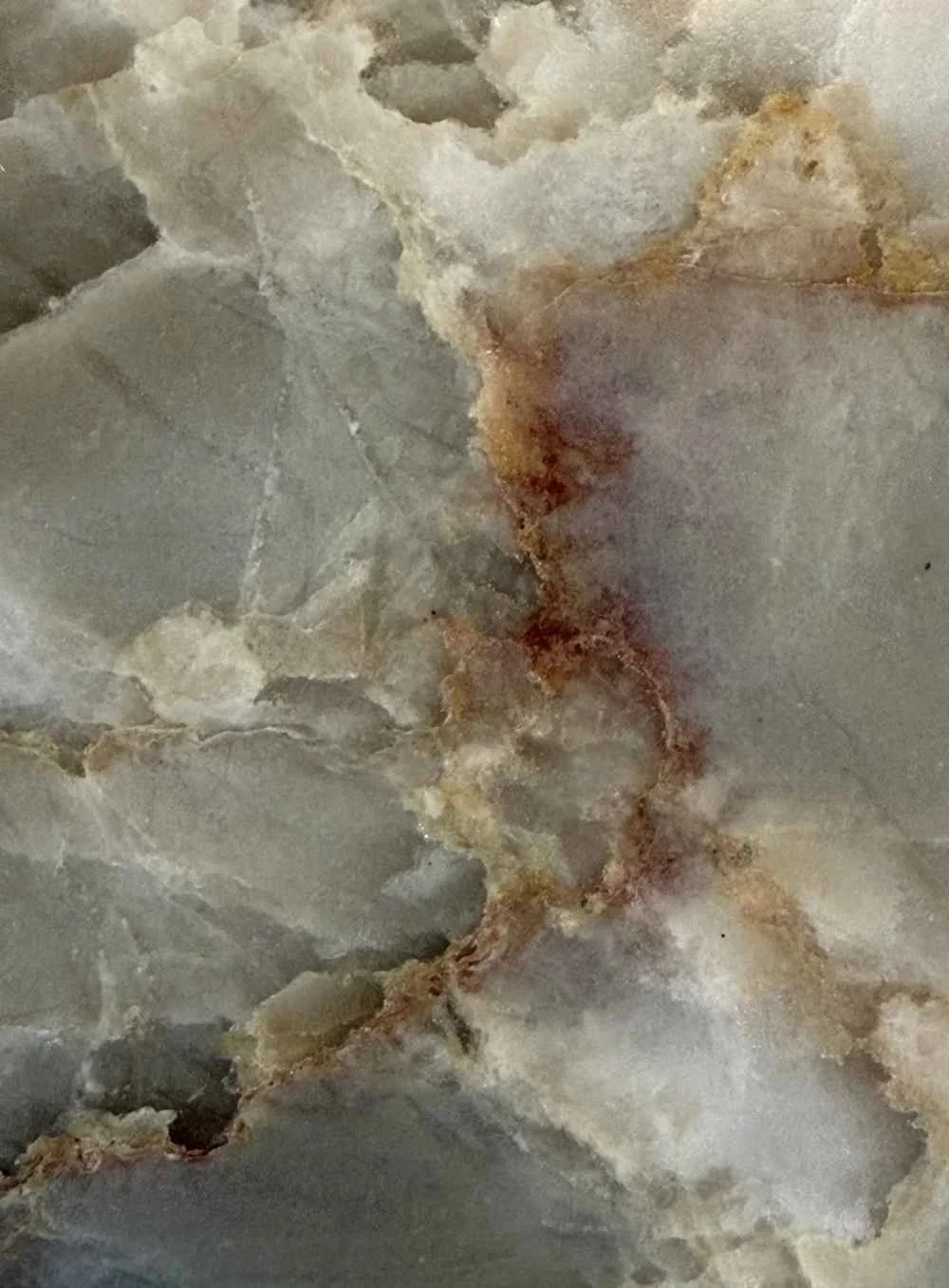 Close-up of a marble or stone surface with natural patterns and veins.