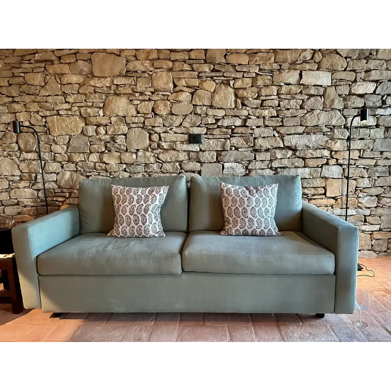 Poolroom sofa in green with pillows
