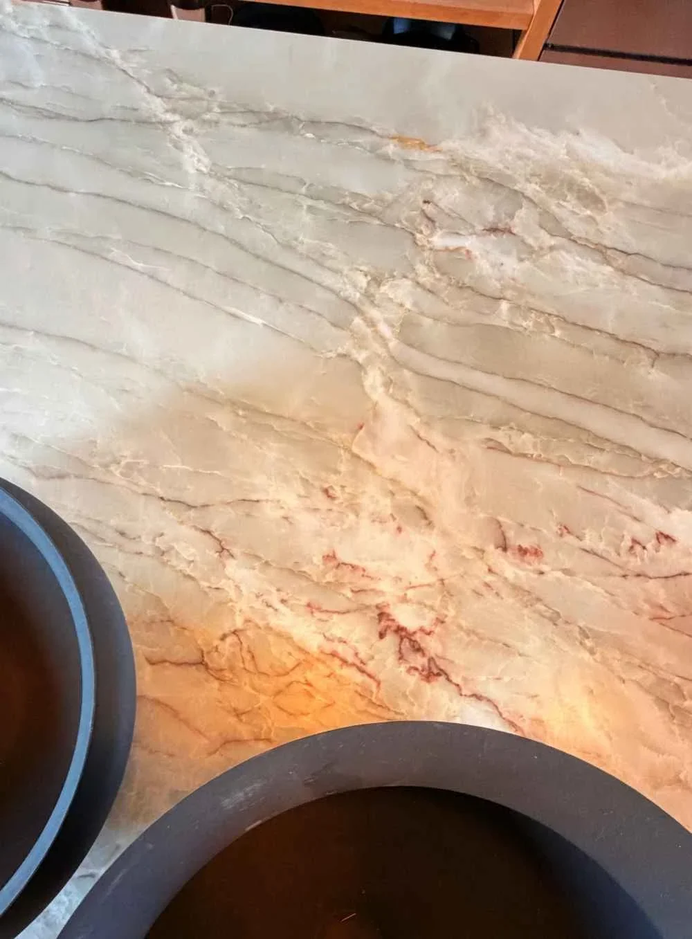 Close-up of a beige marble countertop with natural veining and a polished surface.