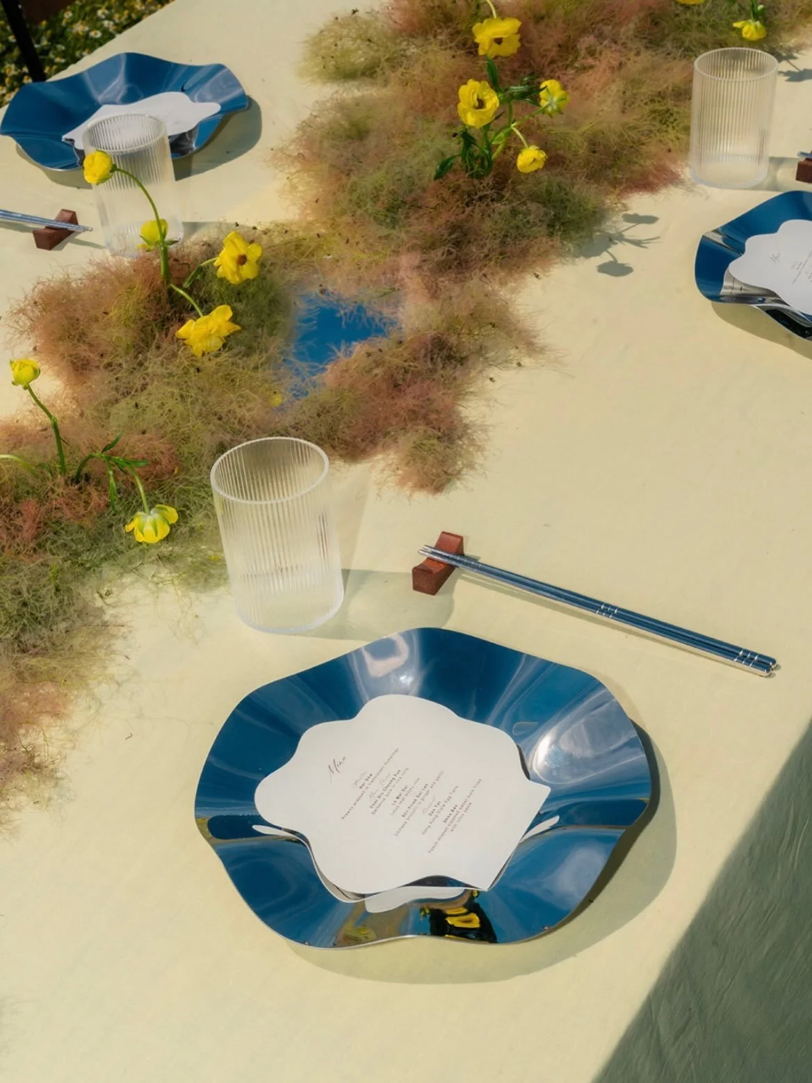 Chrome and butter yellow 🙌💛

A polished take on a whimsical wildflower style table design with chrome tableware and a mirrored floral installation 🪞 refined yet bold with butterfly ranunculus and smokebush 

As seen on @togetherjournal 
Concept, f