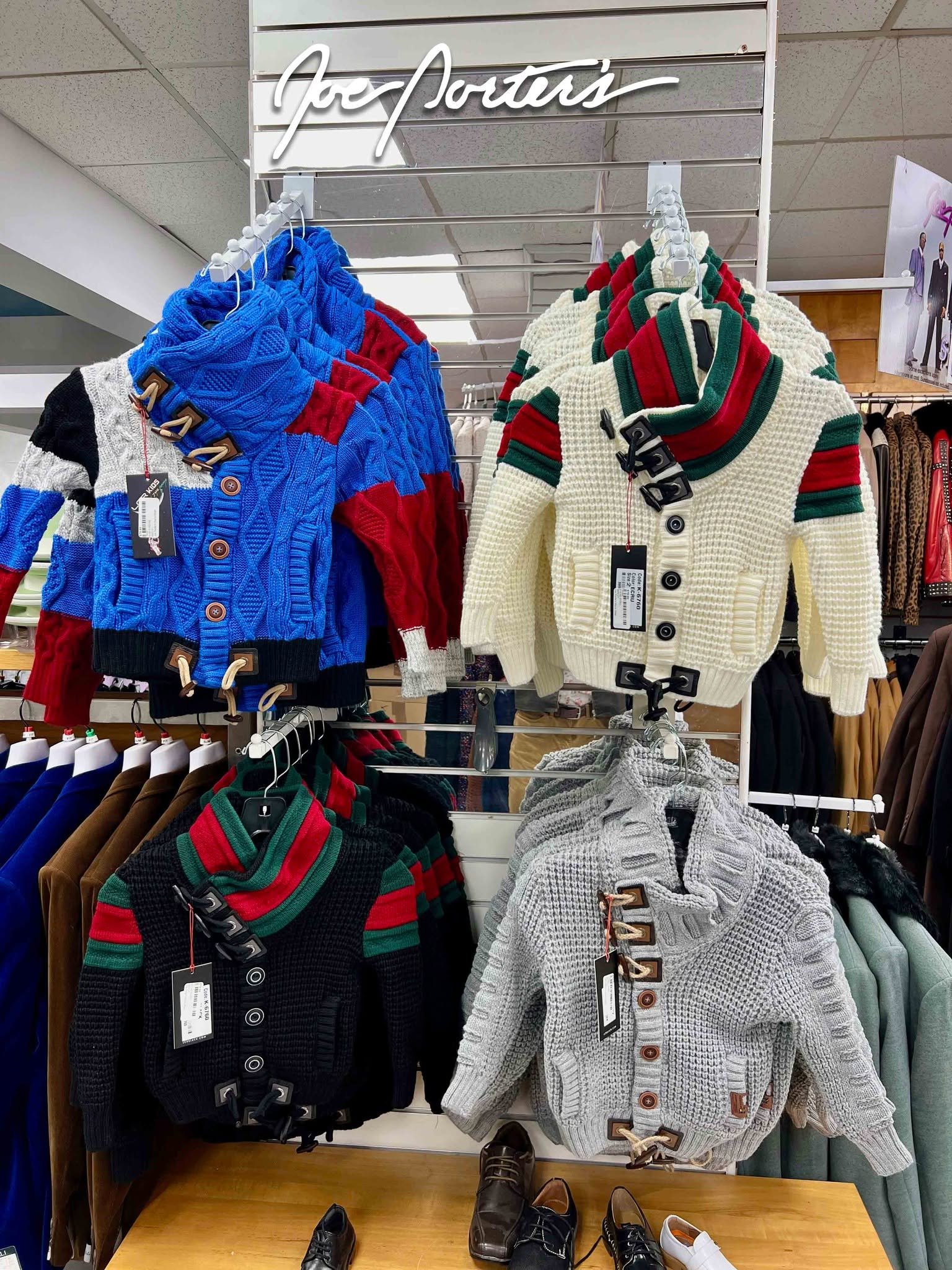 Colorful button-front knit cardigans displayed on racks in a clothing store