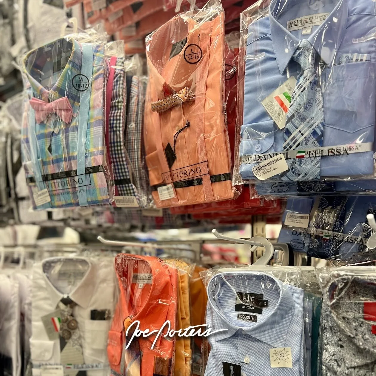 Rack of colorful men’s dress shirts and ties packaged in clear plastic at a clothing store