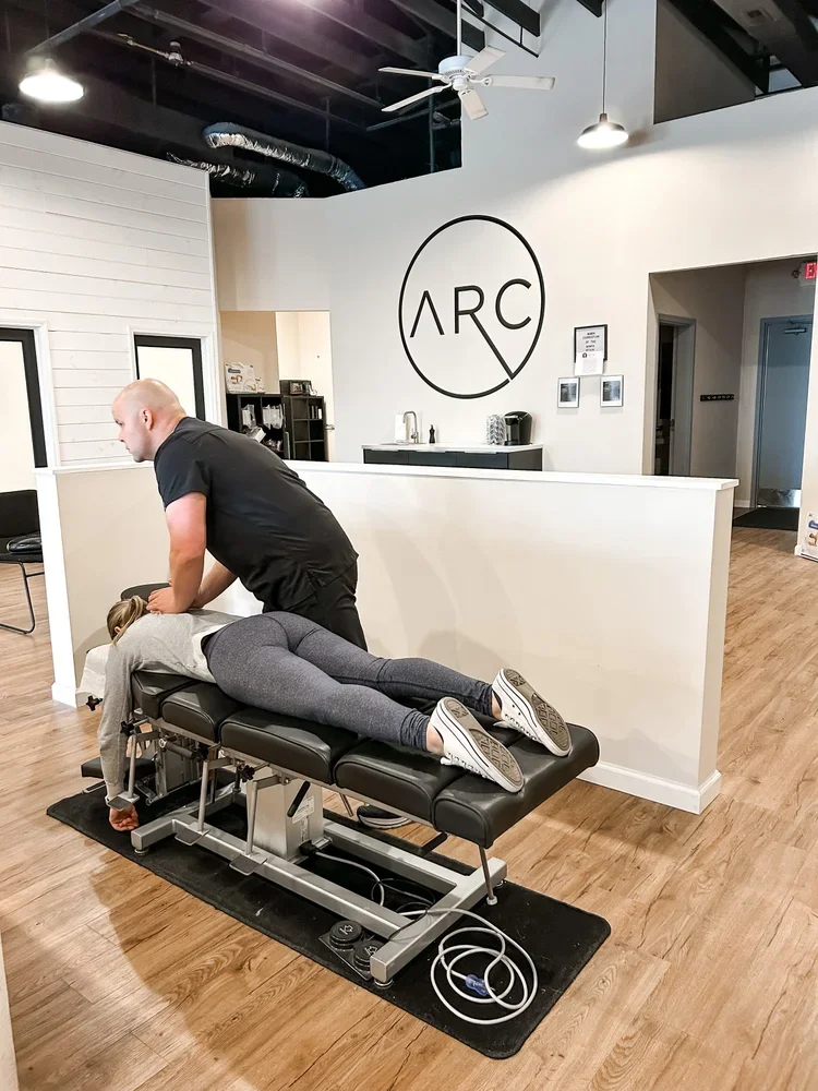 Chiropractor preforming a spinal adjustment on patient