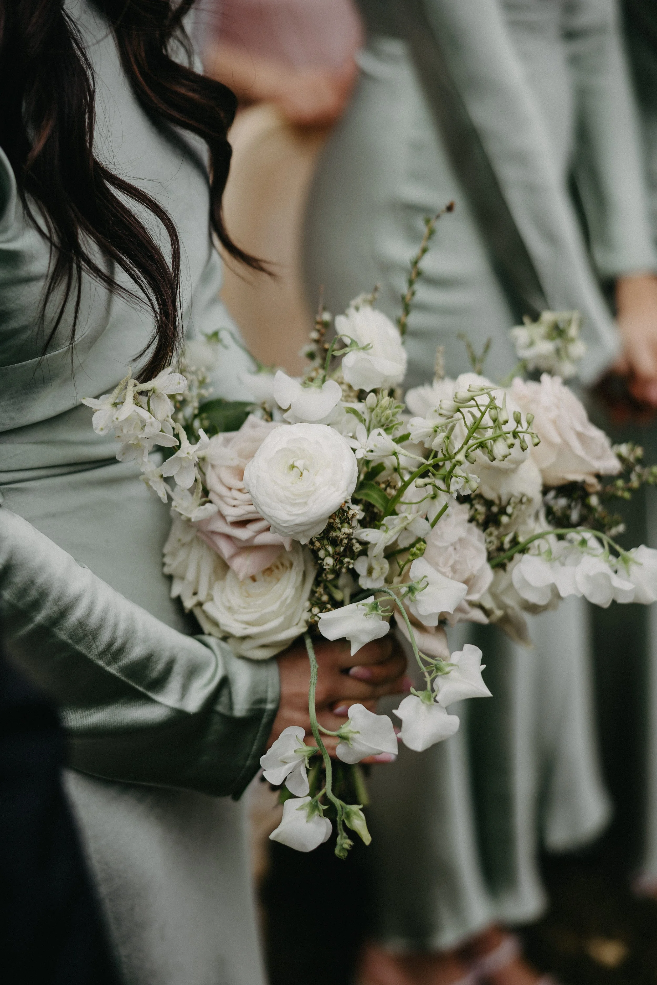 bridesmaids in silk sage dresses with petite green and white bouquet