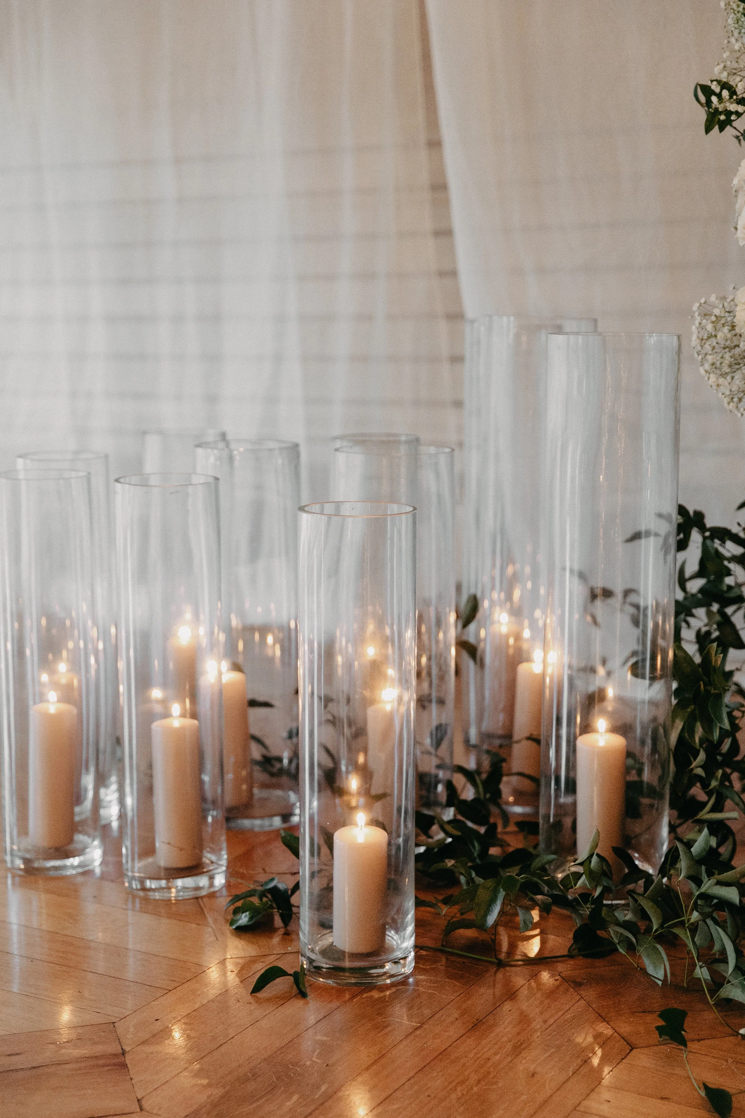 tall hurricane candles with sandstone pillar candles for a winter wedding ceremony at maysara winery