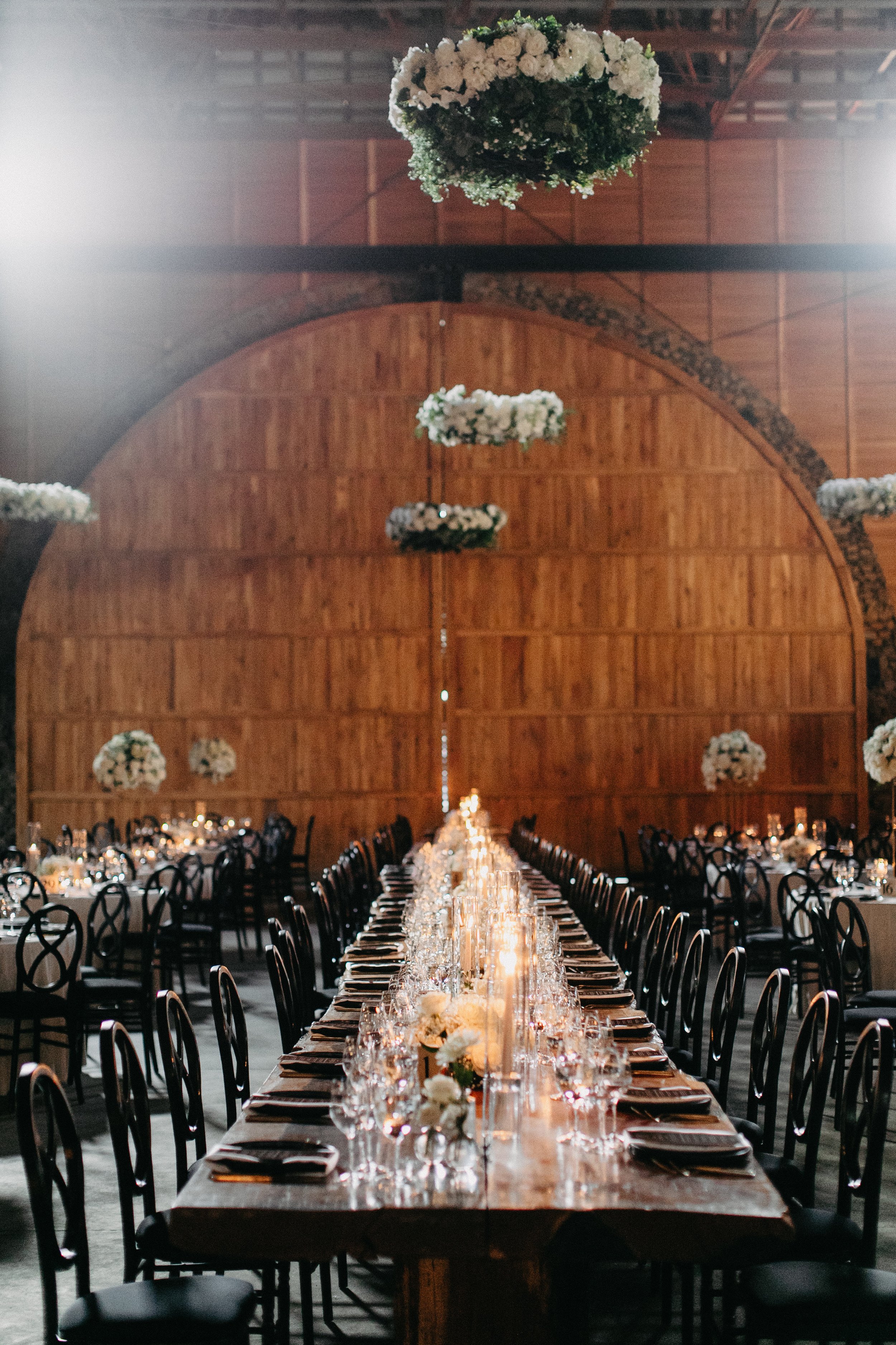 Extra long wedding reception table at moody elegant winter wedding at Maysara Winery with hundreds of candles