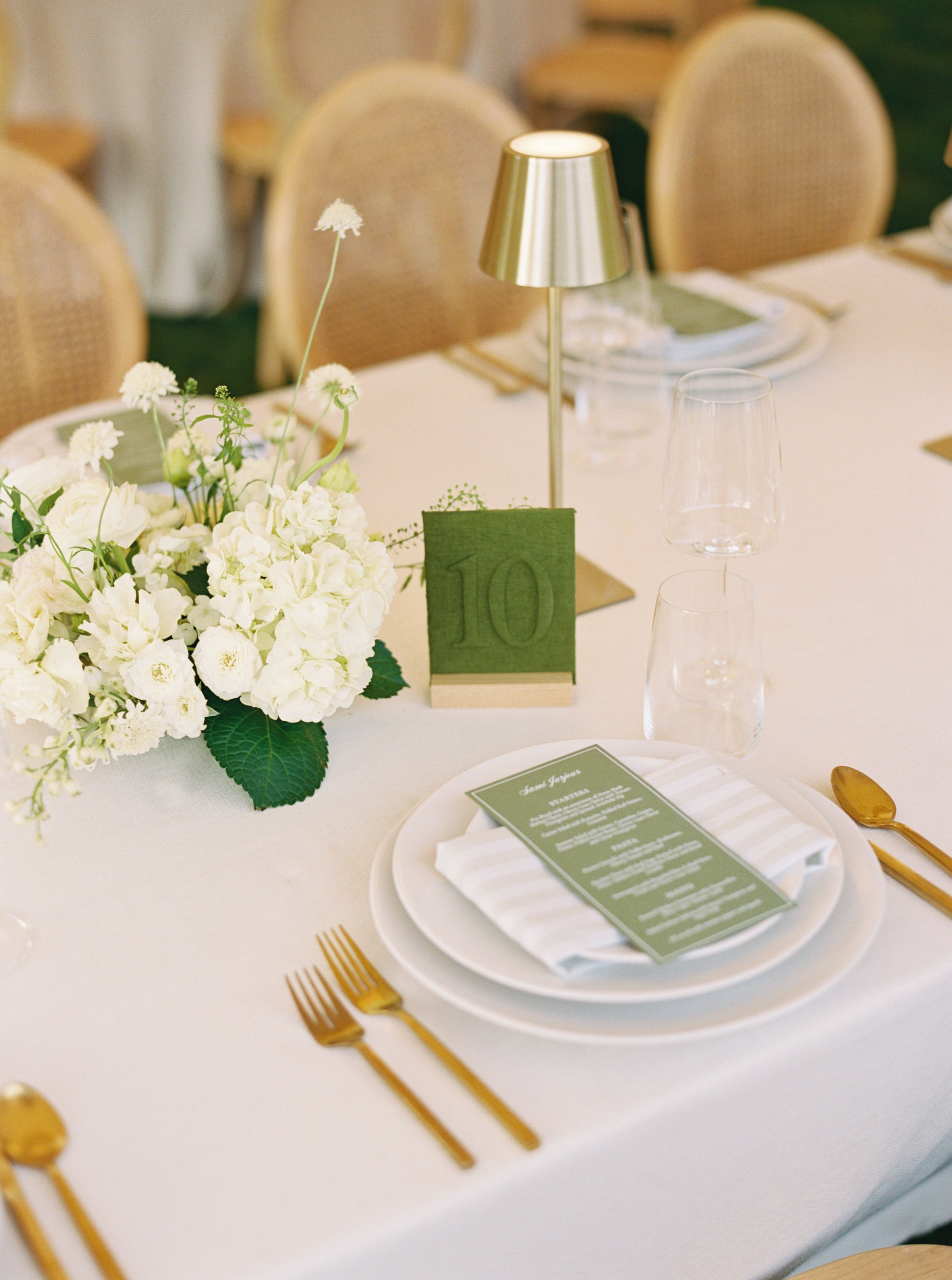 wedding reception table setting with green and white striped napkin and green menu custom linen table number