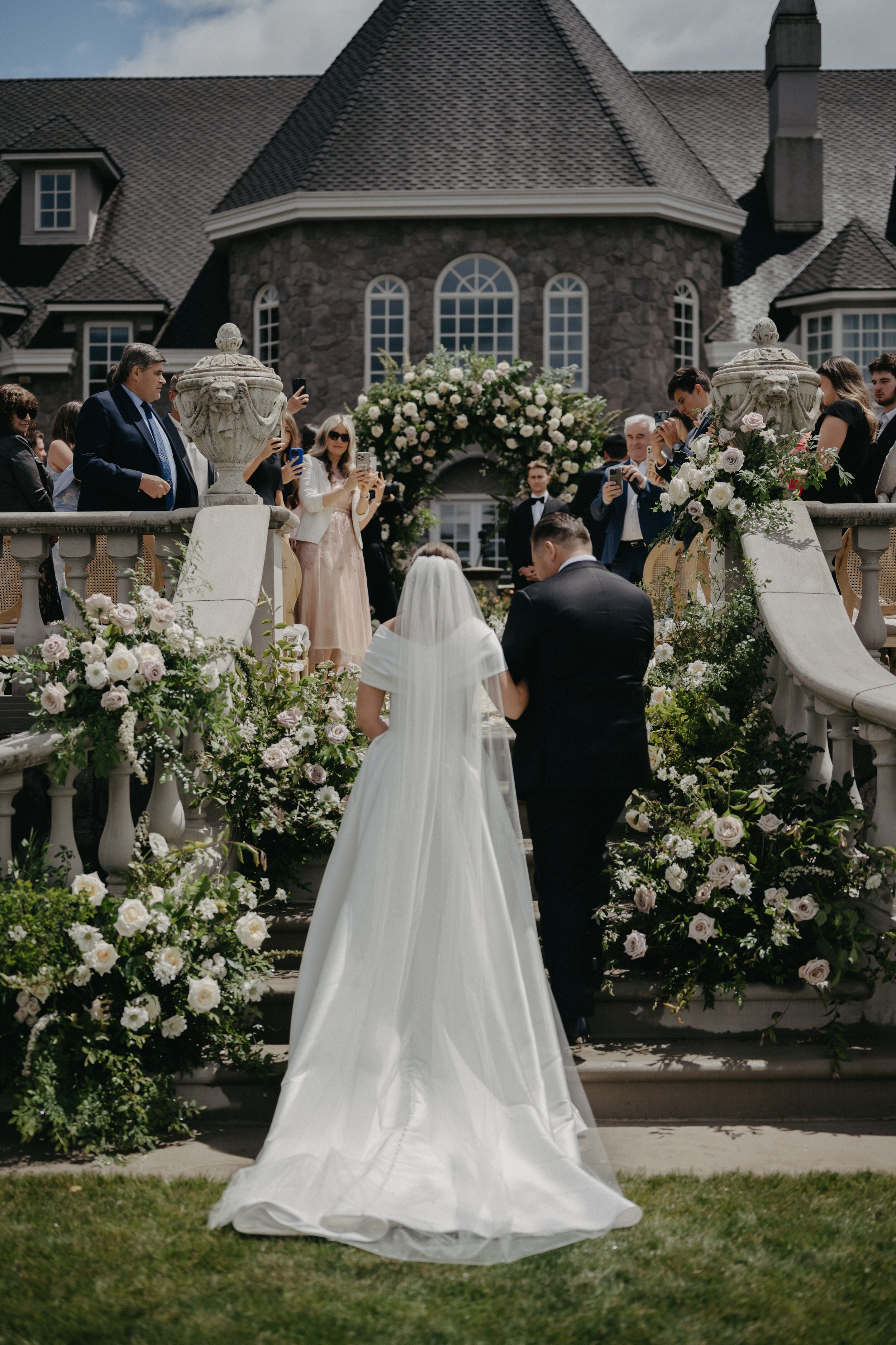 Bride escorted to ceremony by father at Chateau de Michellia