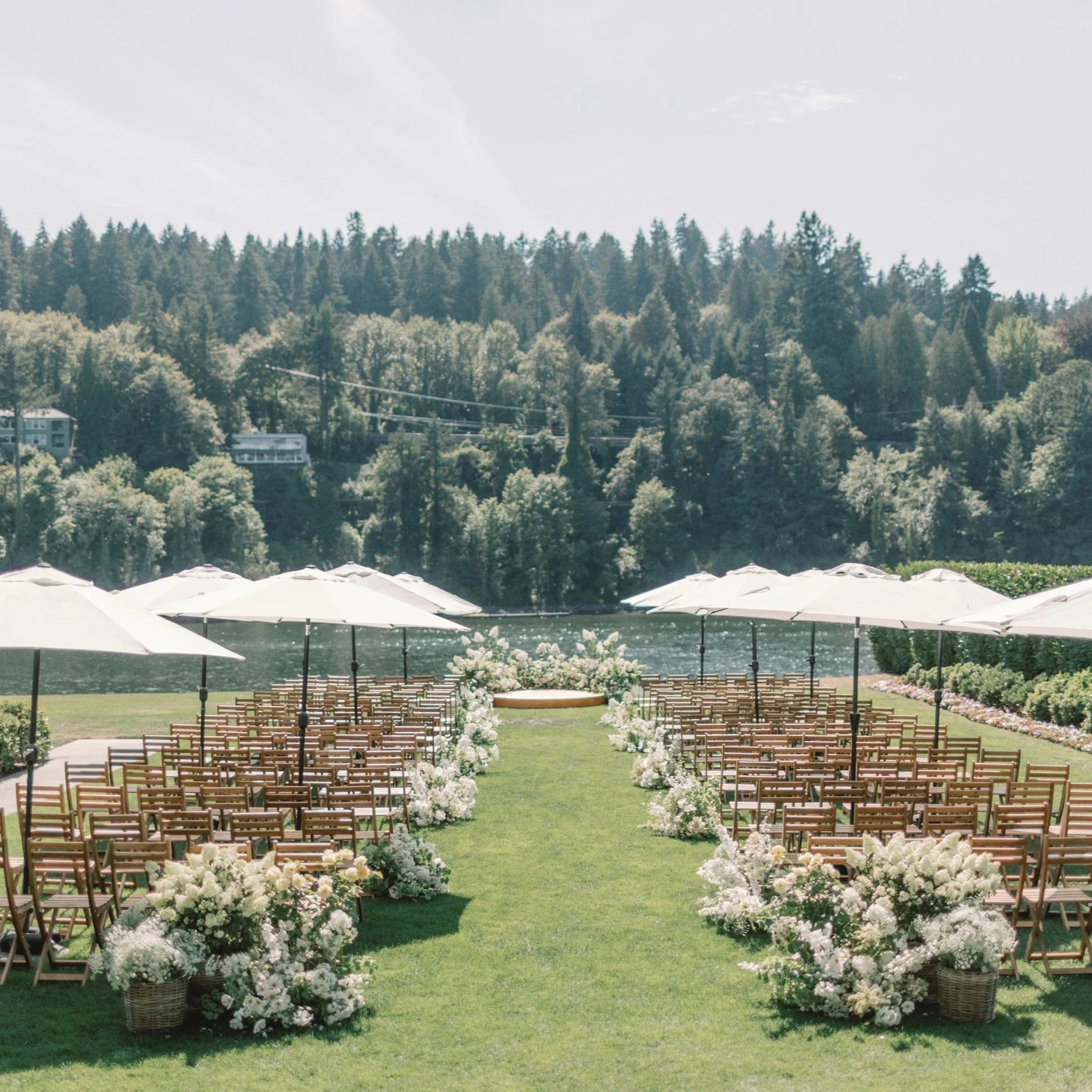Outdoor ceremony in Portland Oregon on river with lush flowers and refined styling.