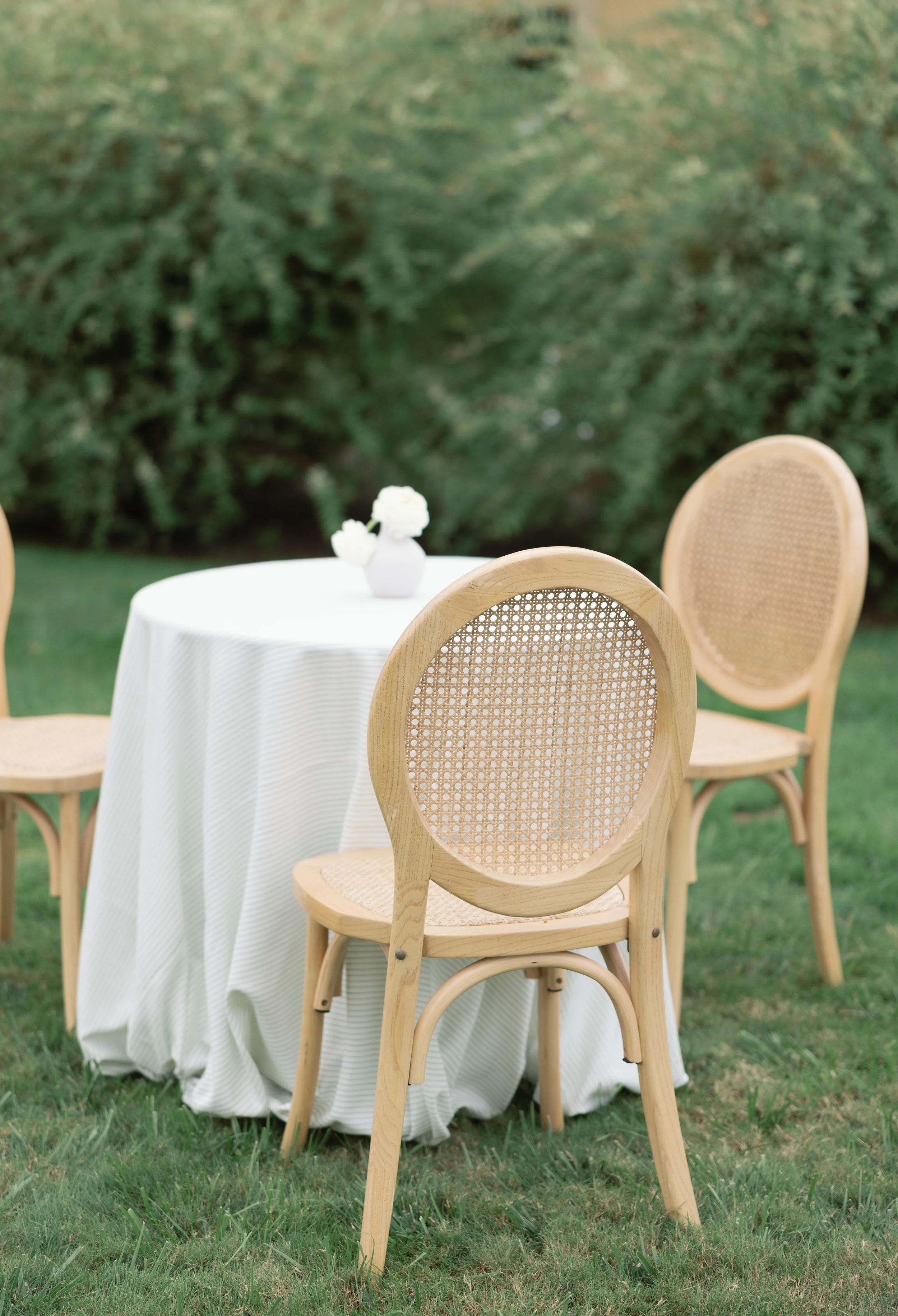 Cocktail tables wedding reception bud vase and light wood rattan chair