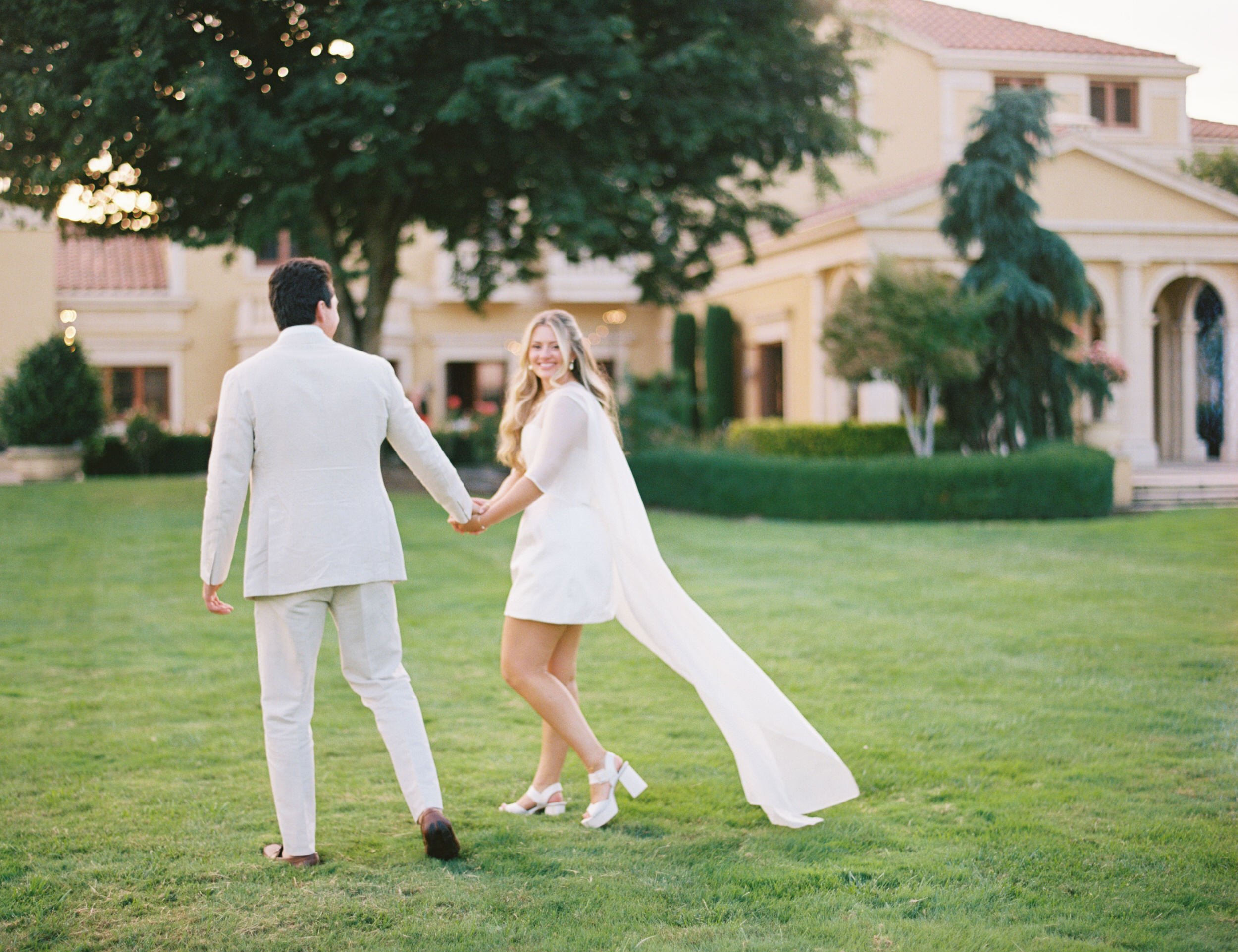 Bride and groom walking at sunset