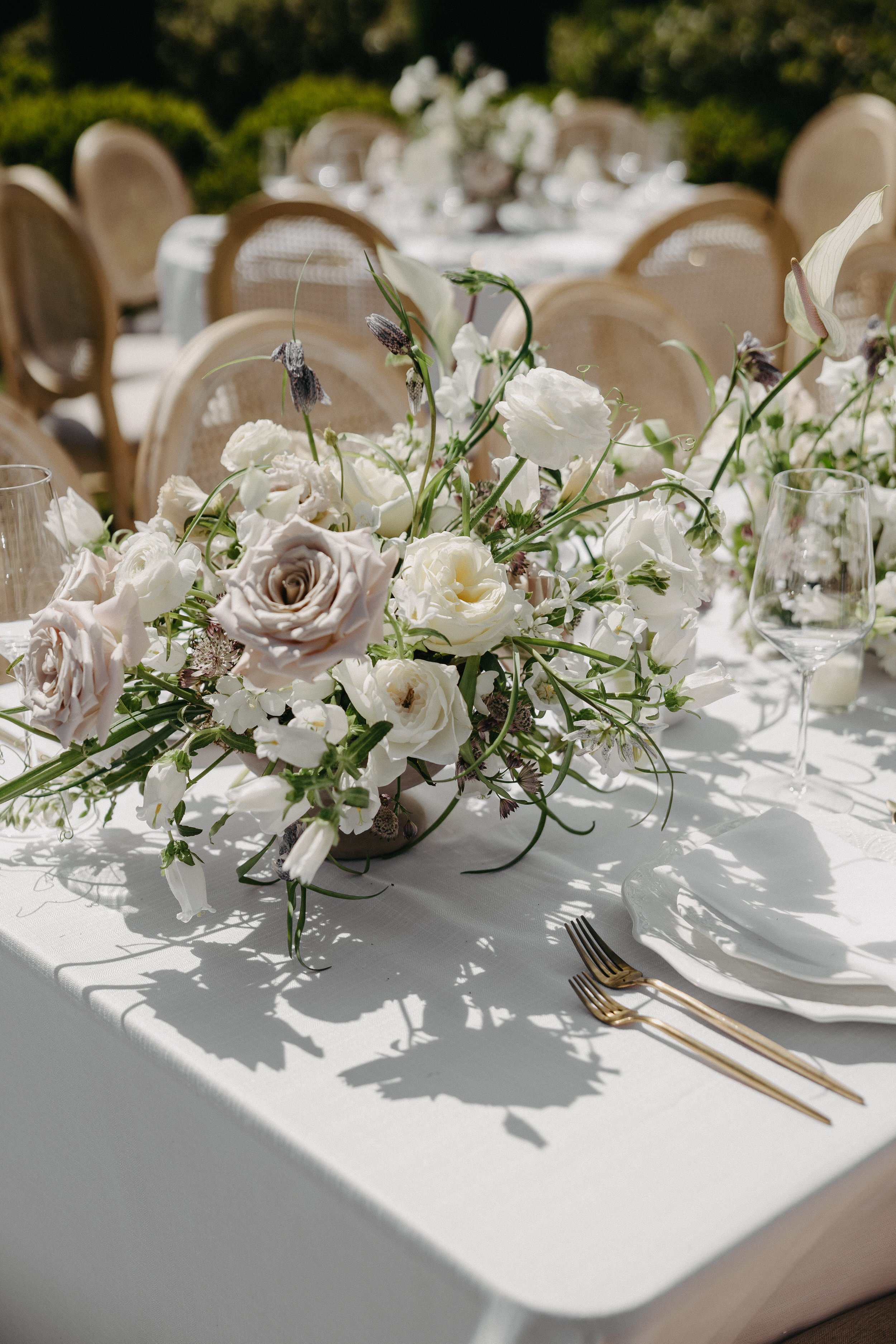 lush white and mauve floral wedding centerpiece