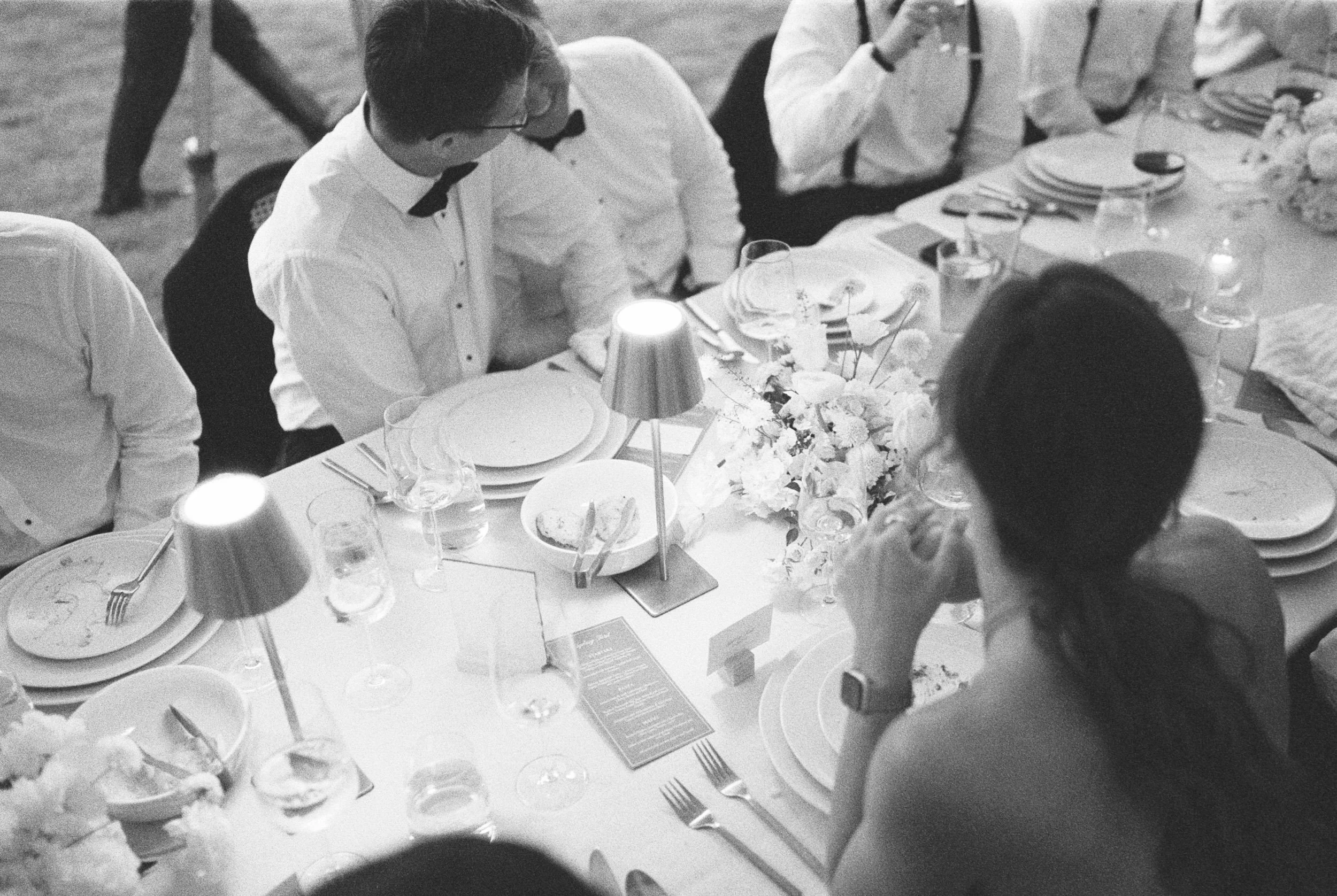 black and white wedding reception overhead photo of guests eating