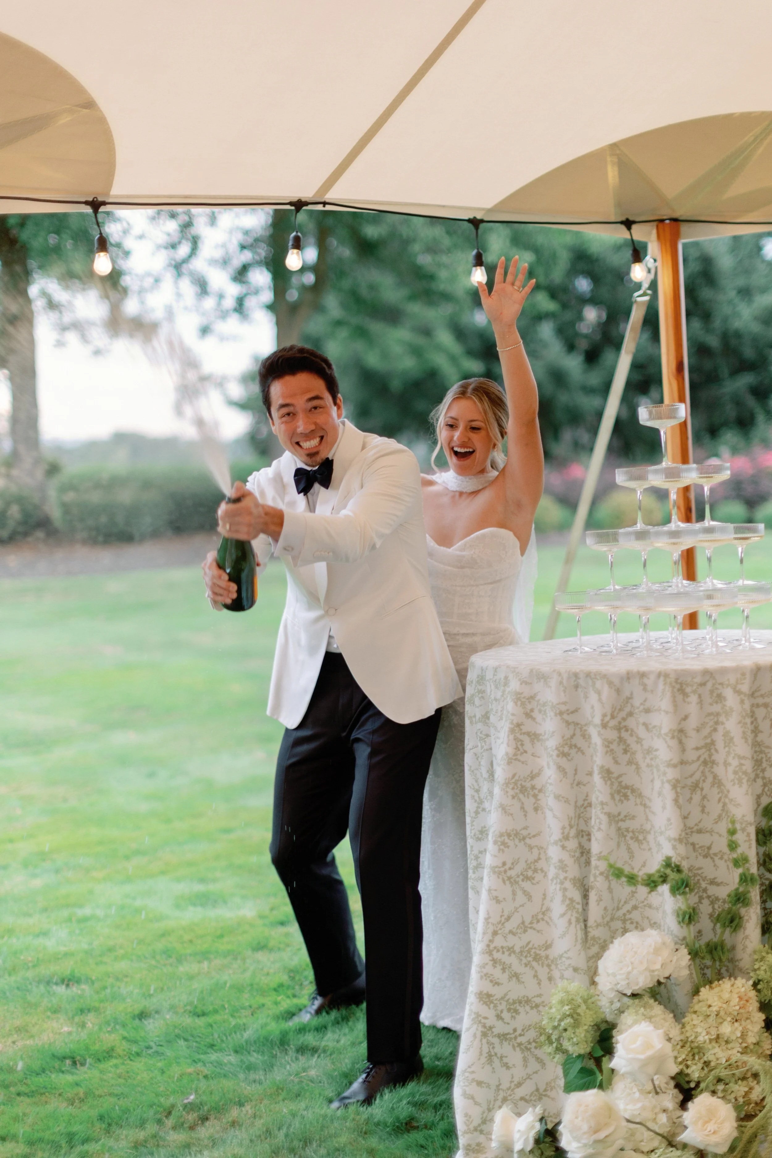 Groom sprays champagne at champagne tower Dundee Oregon