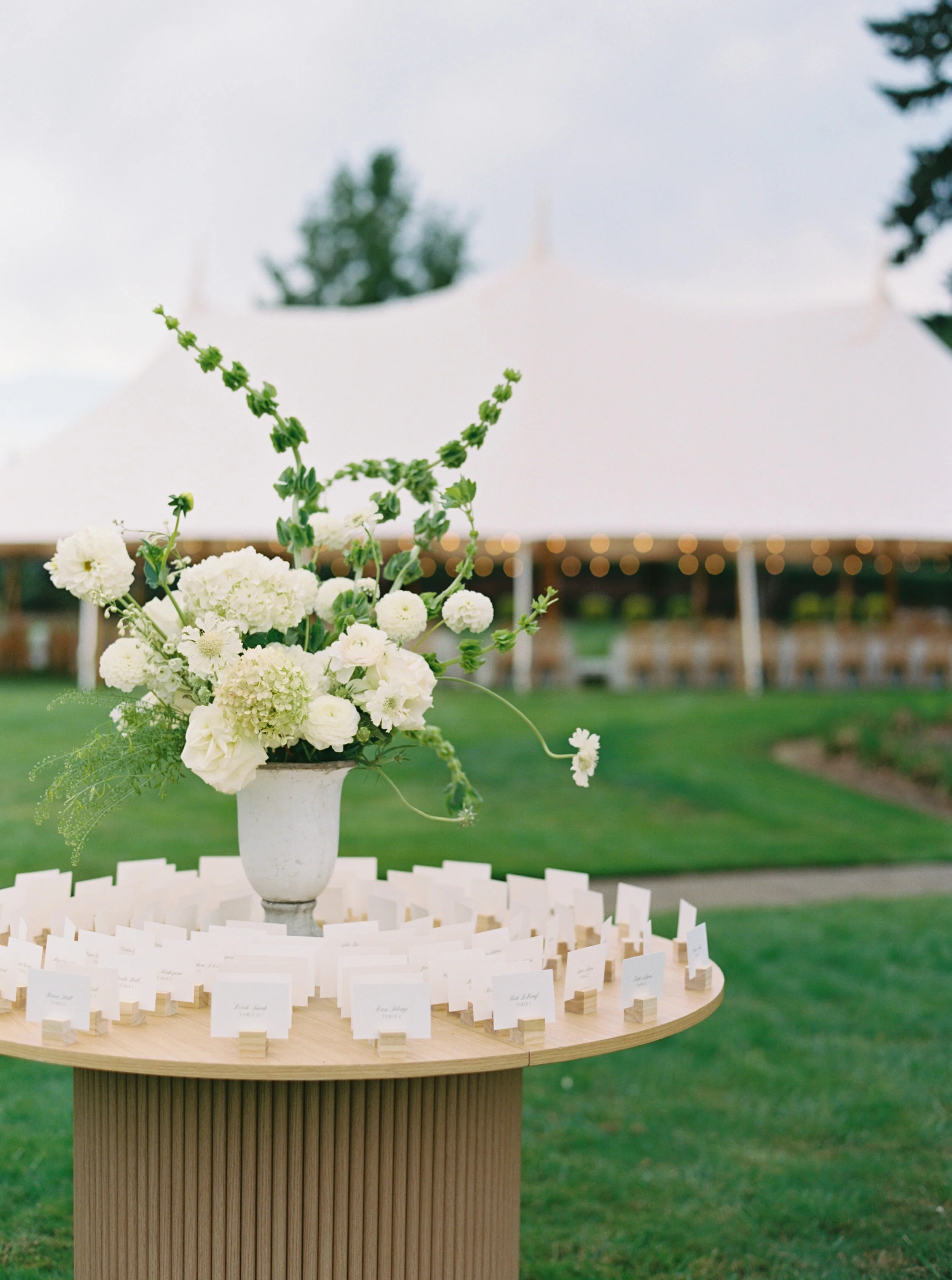 Wedding reception seating chart on circular wood table