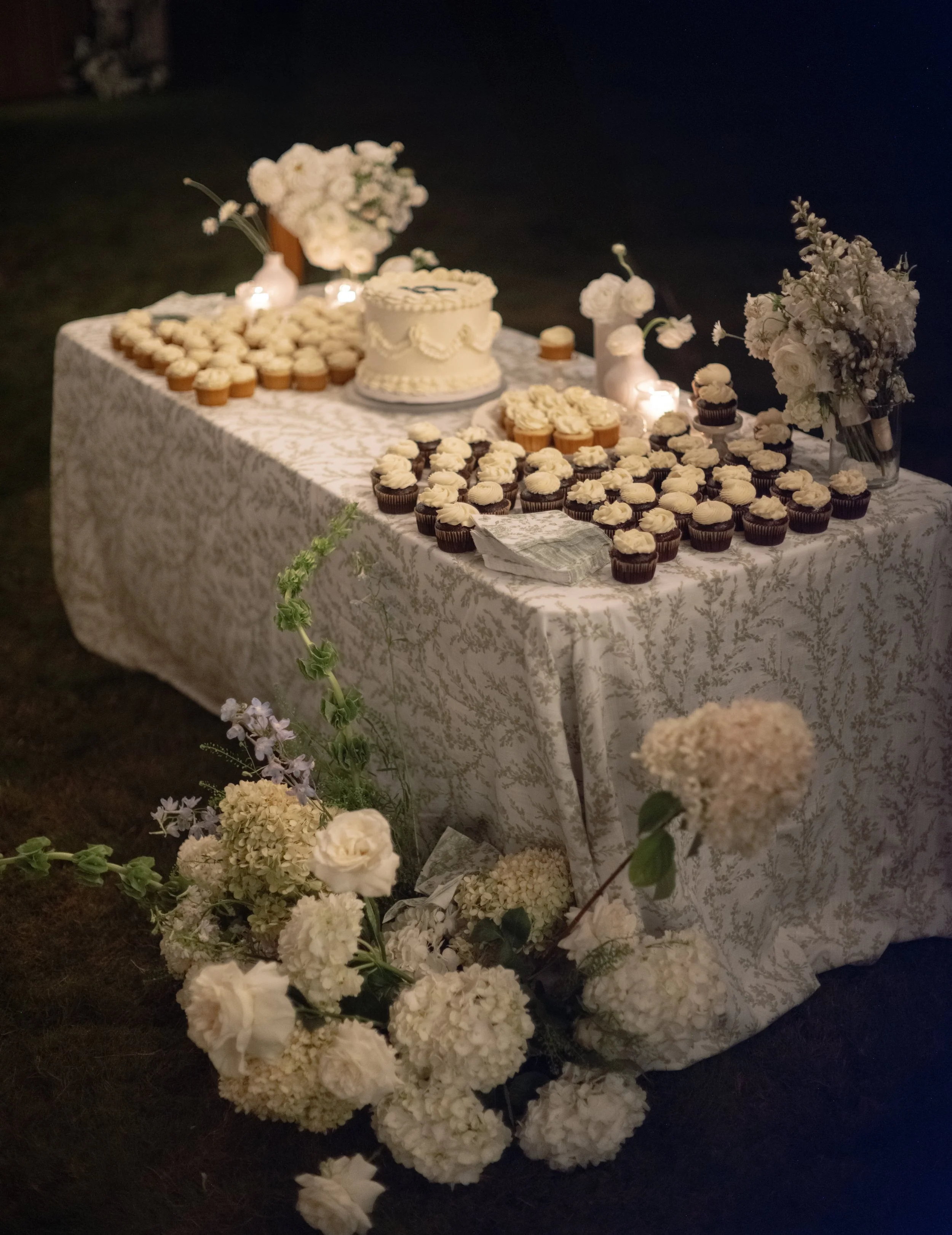 wedding reception dessert table with green and white linen