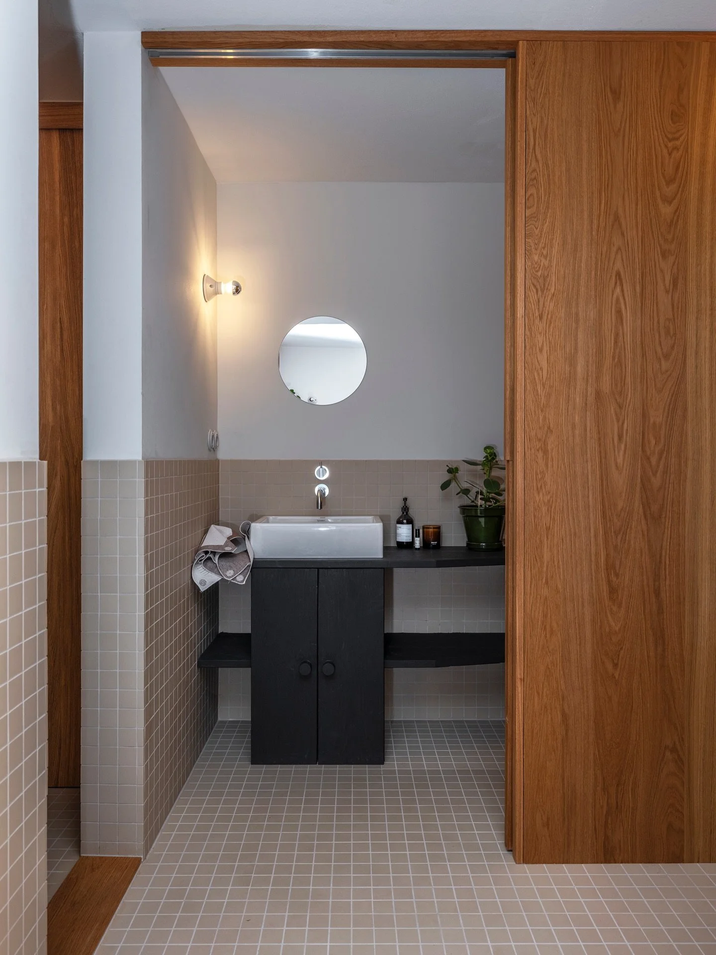 Have you considered dividing the bathroom into a public and a private part? 

In an apartment at Hellerud in Oslo, @studio_et_al has designed an ingenious bathroom solution. The bathroom leads directly from the hallway, but instead of hiding it behin