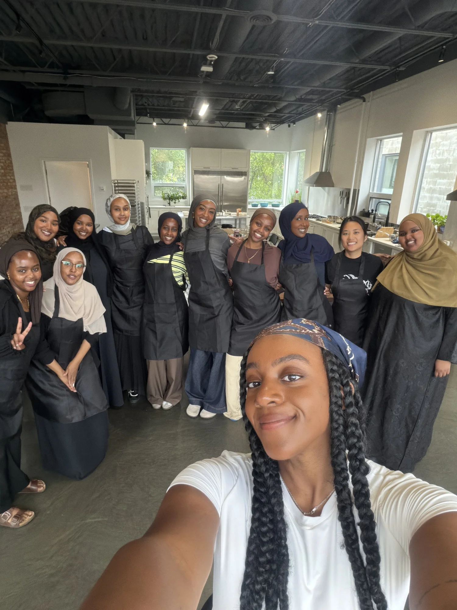 Workshop group in aprons smiling together in the kitchen