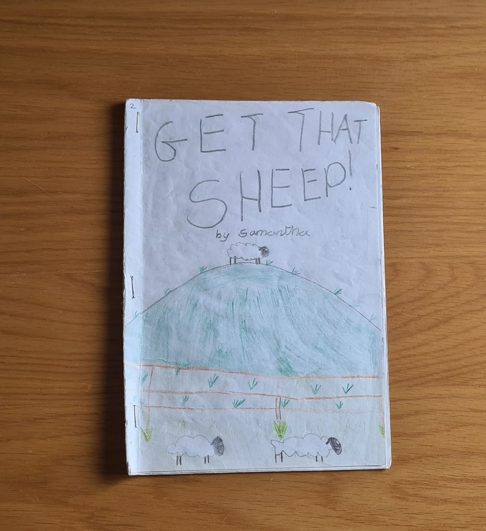 Get That Sheep: A hand drawn image of a sheep on a hill.