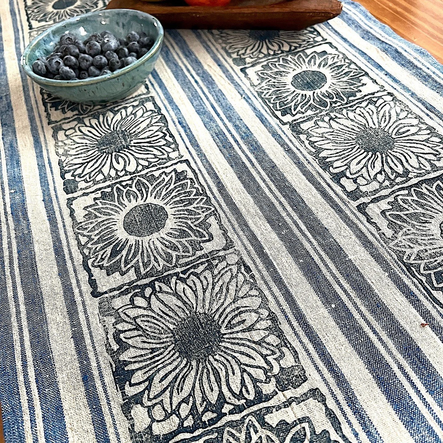 Sunflowers printed on stripy linen.