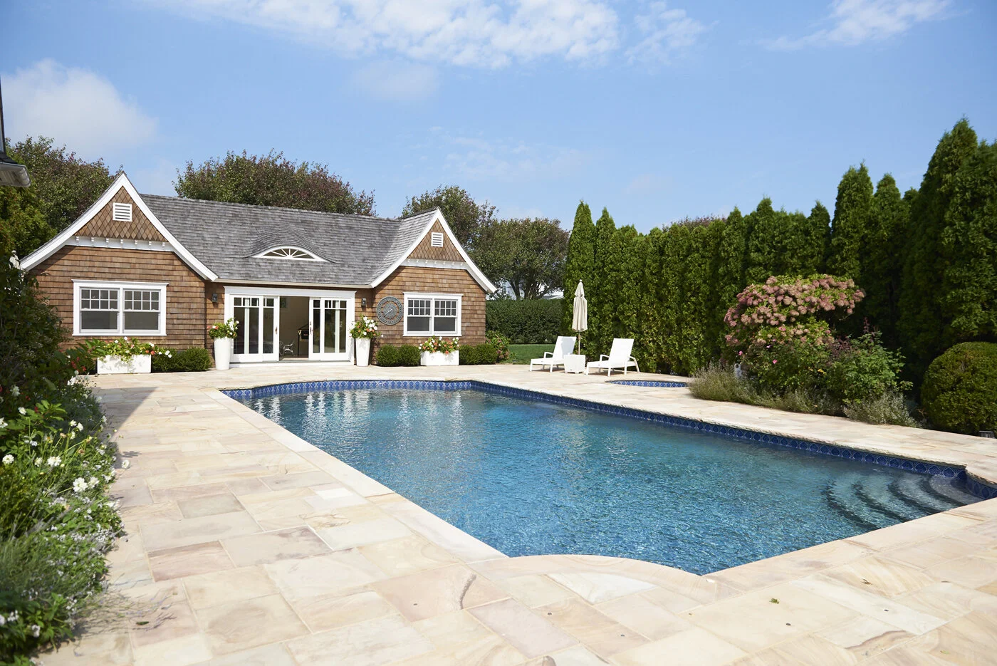 view of pool and house designed by Hamptons architect Ernest Schieferstein
