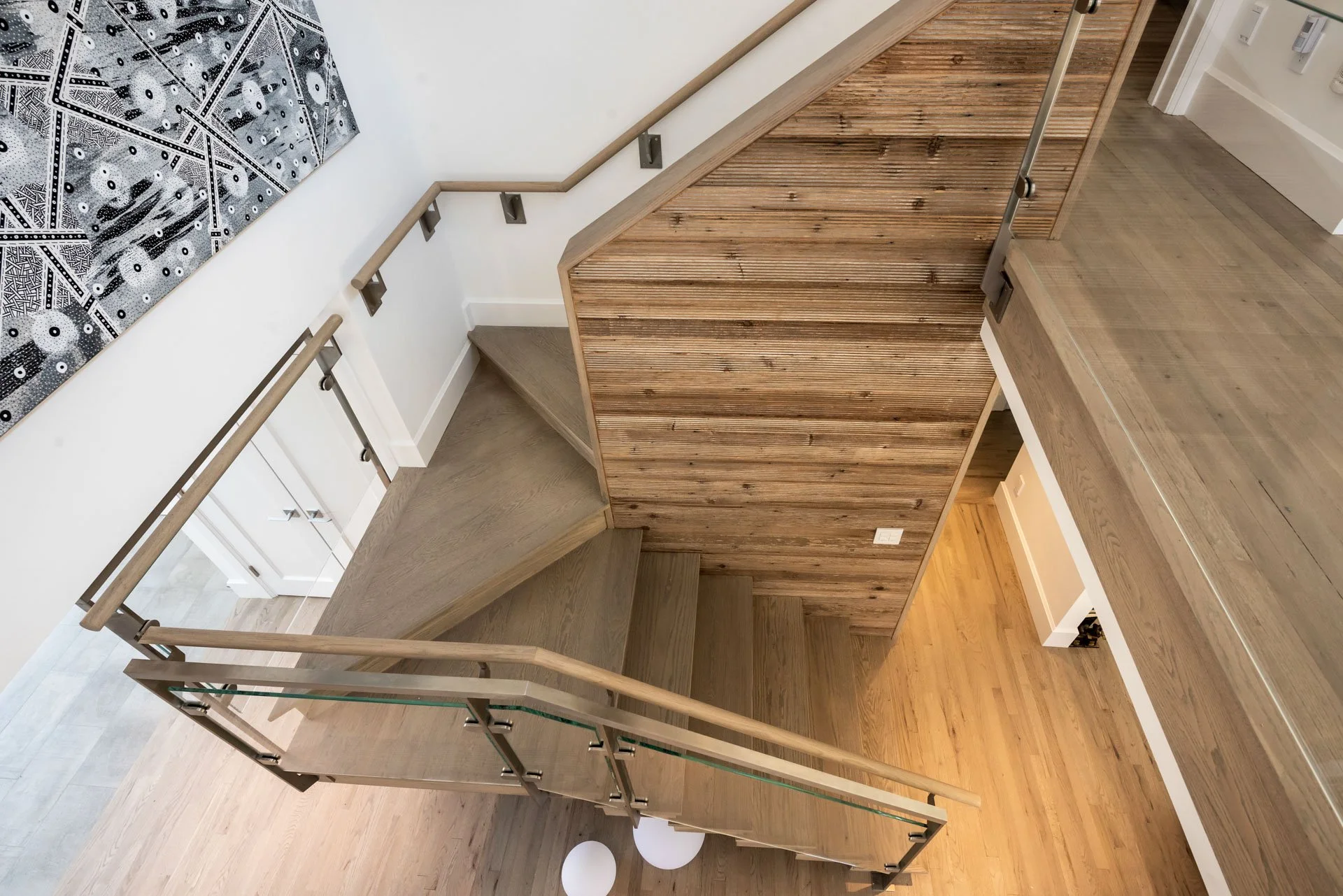 second floor view of staircase in modern Hamptons home designed by architect Ernest Schieferstein