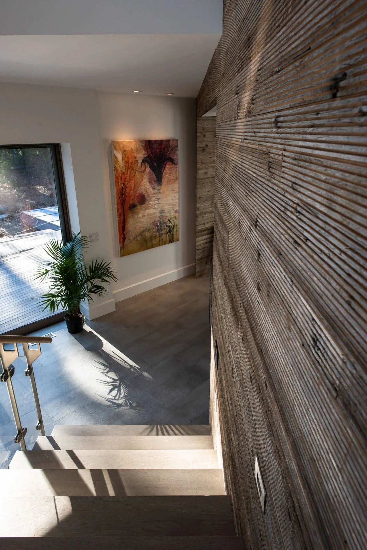 Another view of staircase from second floor in modern Hamptons home designed by Hamptons architect Ernest Schieferstein