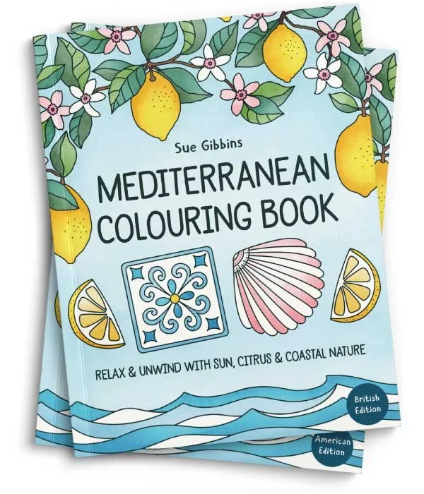 Two books, one on top of the other, entitled Mediterranean Colouring Book. The cover features lemon tree branches on a blue background. The top book has a sticker saying British edition and the lower book is American edition.