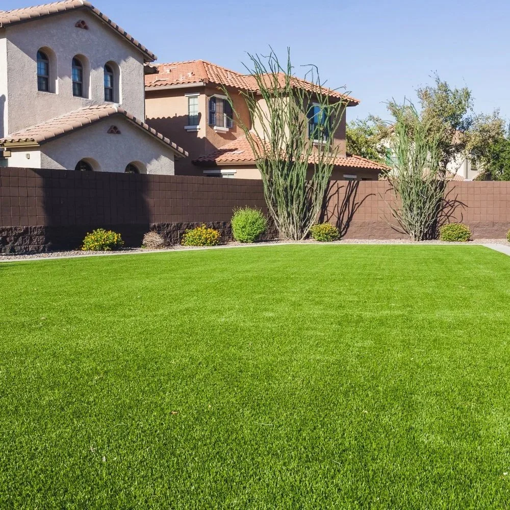 A vibrant green artificial turf playground at a Phoenix school, featuring a smooth, safe surface ideal for year-round student activity.