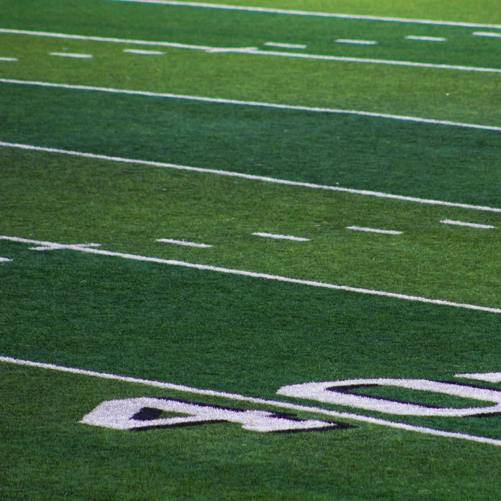 Professional installers laying high-quality synthetic turf on a Phoenix school playground, ensuring a safe, durable, and heat-resistant surface for students.