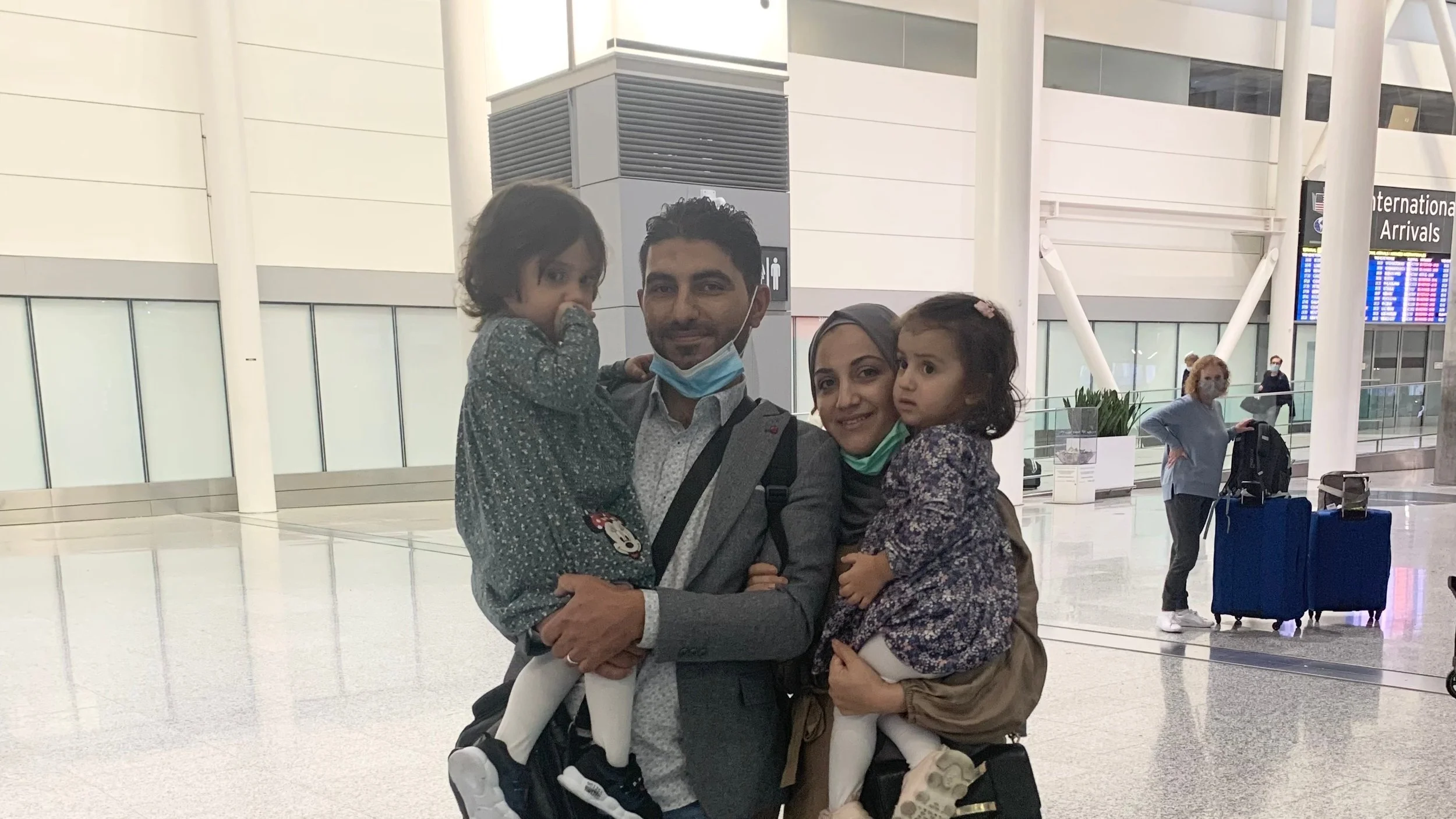 A photo of Hozifa, his wife Yasemin, and their two children at Toronto Pearson International Airport on their arrival in Canada.