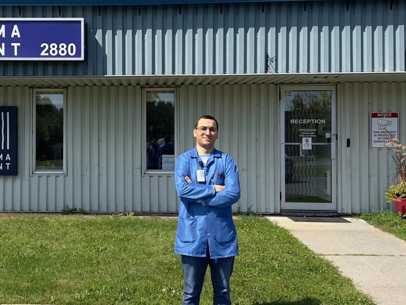 Engineer and Syrian refugee Hamzah stands in front of SigmaPoint's office in Cornwall, Ontario.