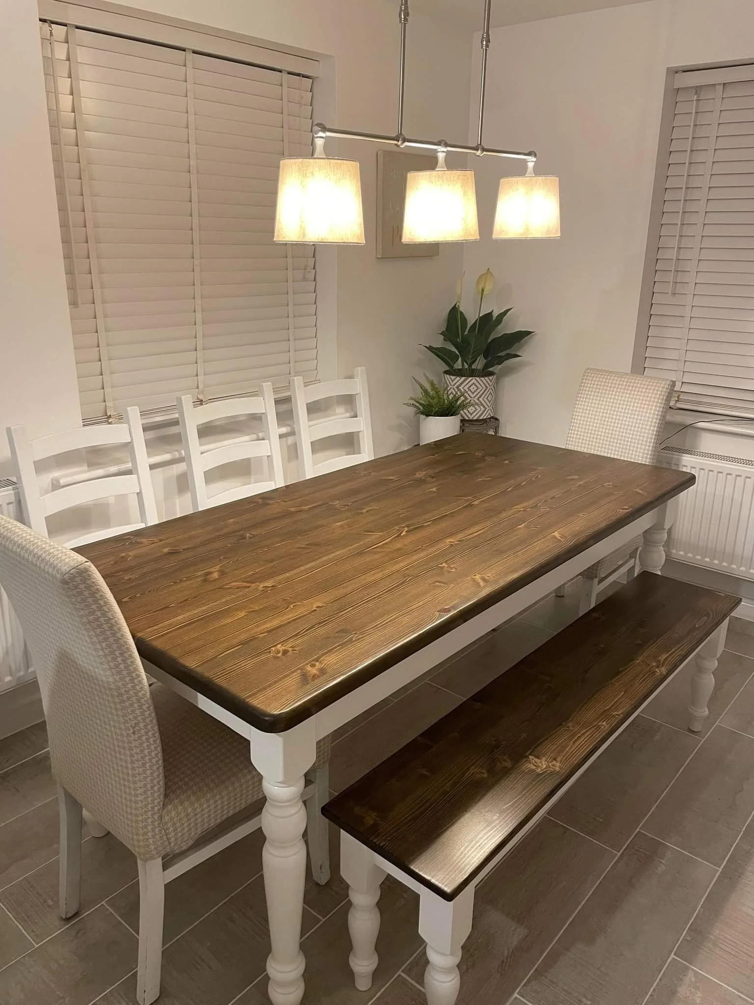 white painted farmhouse table and bench with walnut stained top