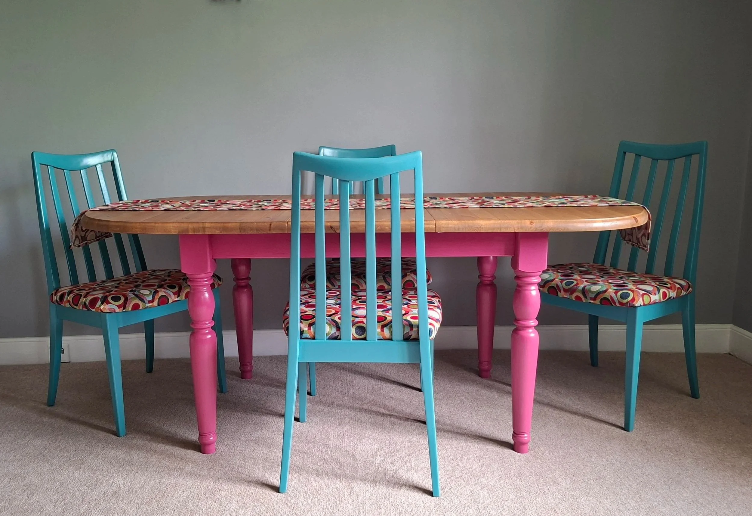 Painted vibrant pink pine table and teal mcm chairs