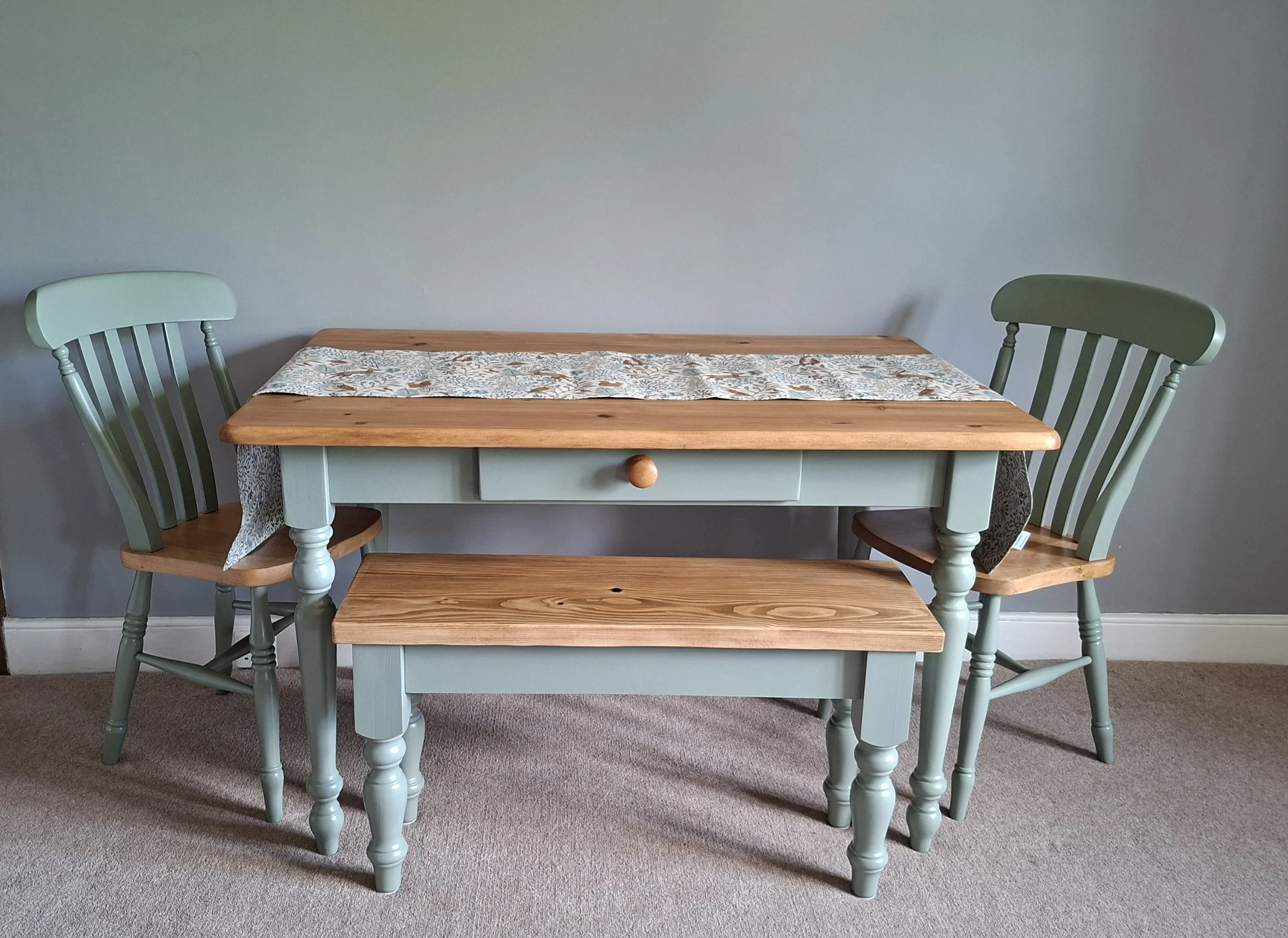 Sage green painted farmhouse pine table with farmhouse bench and chairs