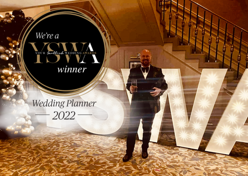 Oskar holding an award