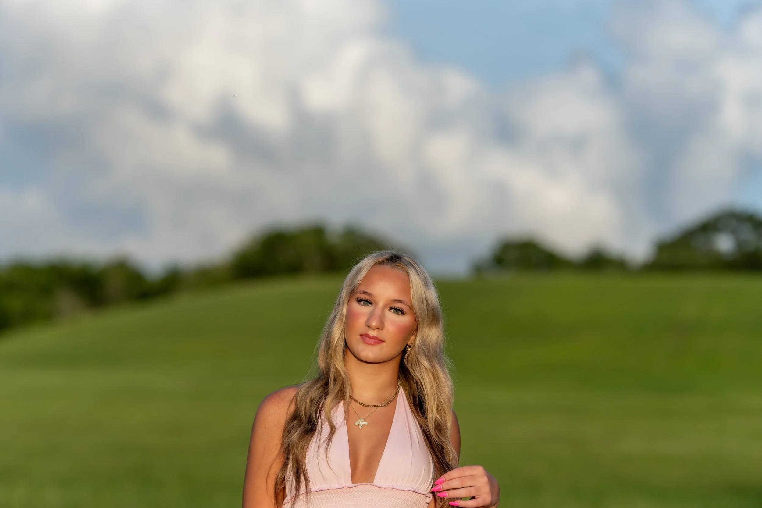 Outdoor spring portrait session in Webster Texas with natural greenery and soft lighting