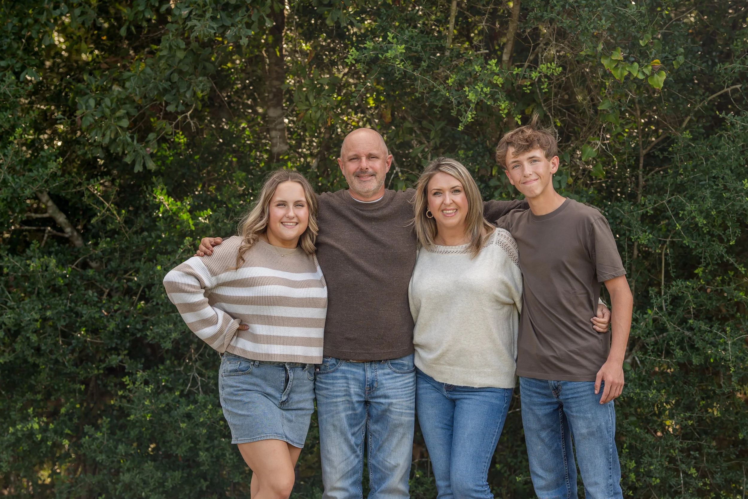 Family photo session at Challenger Park in Webster TX during spring mini sessions with soft natural light