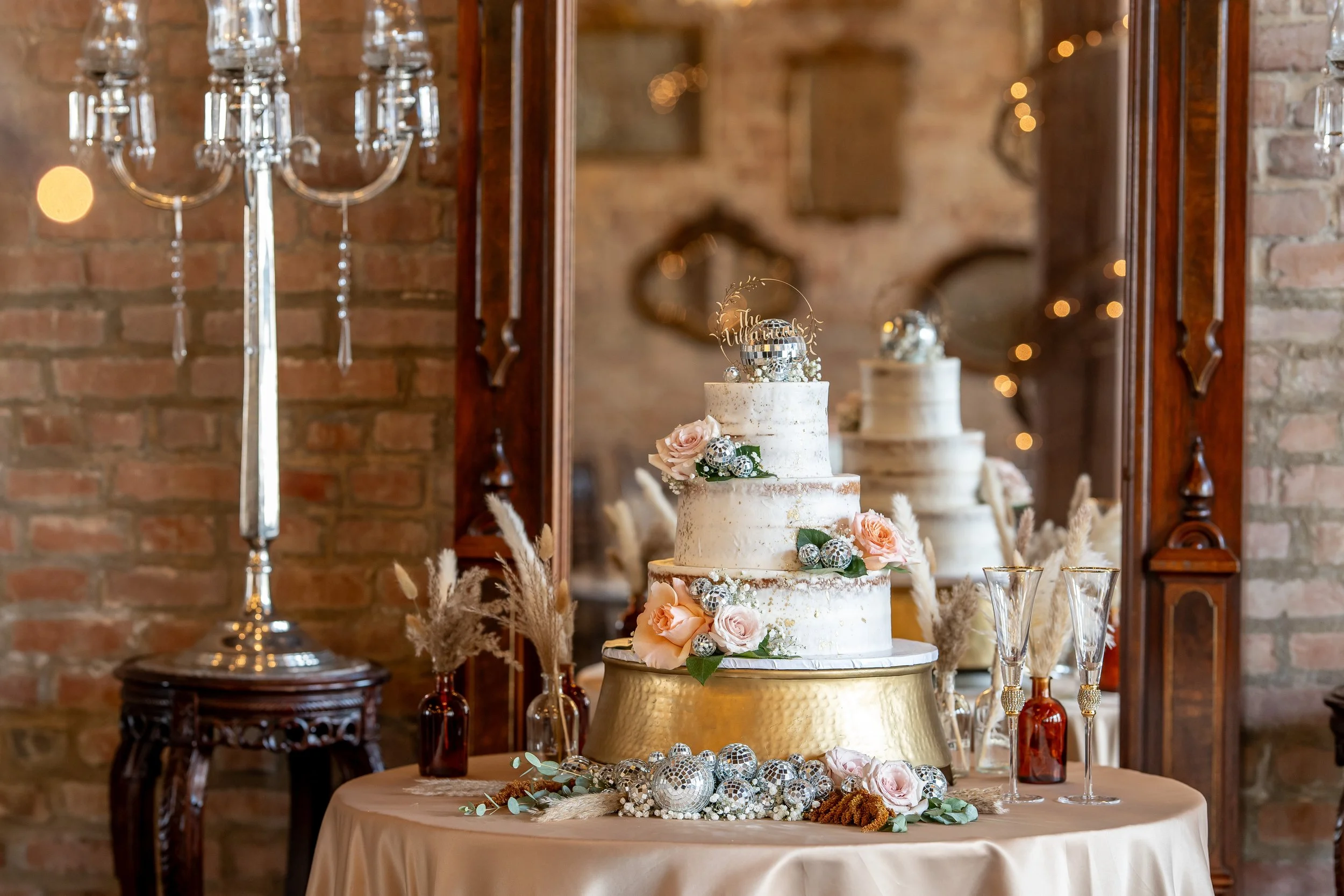 Wedding cake by Cakes by Jula at Butler’s Courtyard in League City Texas with elegant floral details and reception decor