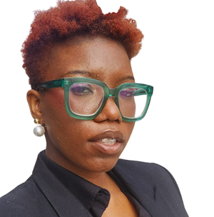 Peace Akintade wears green glasses. She has short hair and is looking thoughtfully at the camera.