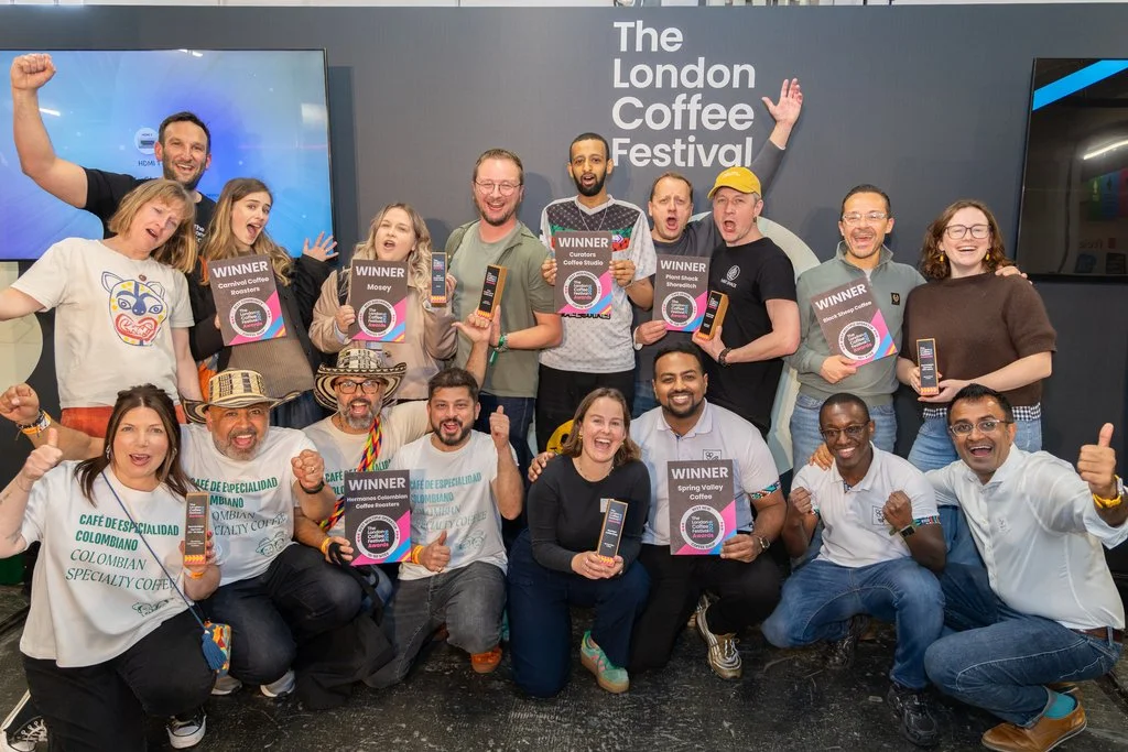 A group of award winners standing together all holding their awards at London Coffee Festival Awards