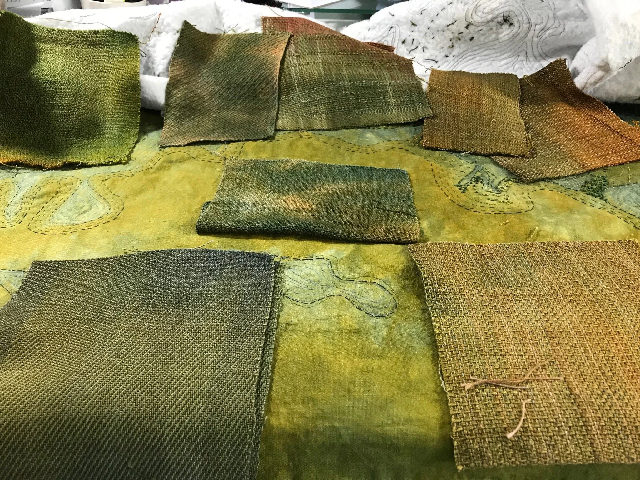 Selecting handwoven cloth to use in the quilt.
