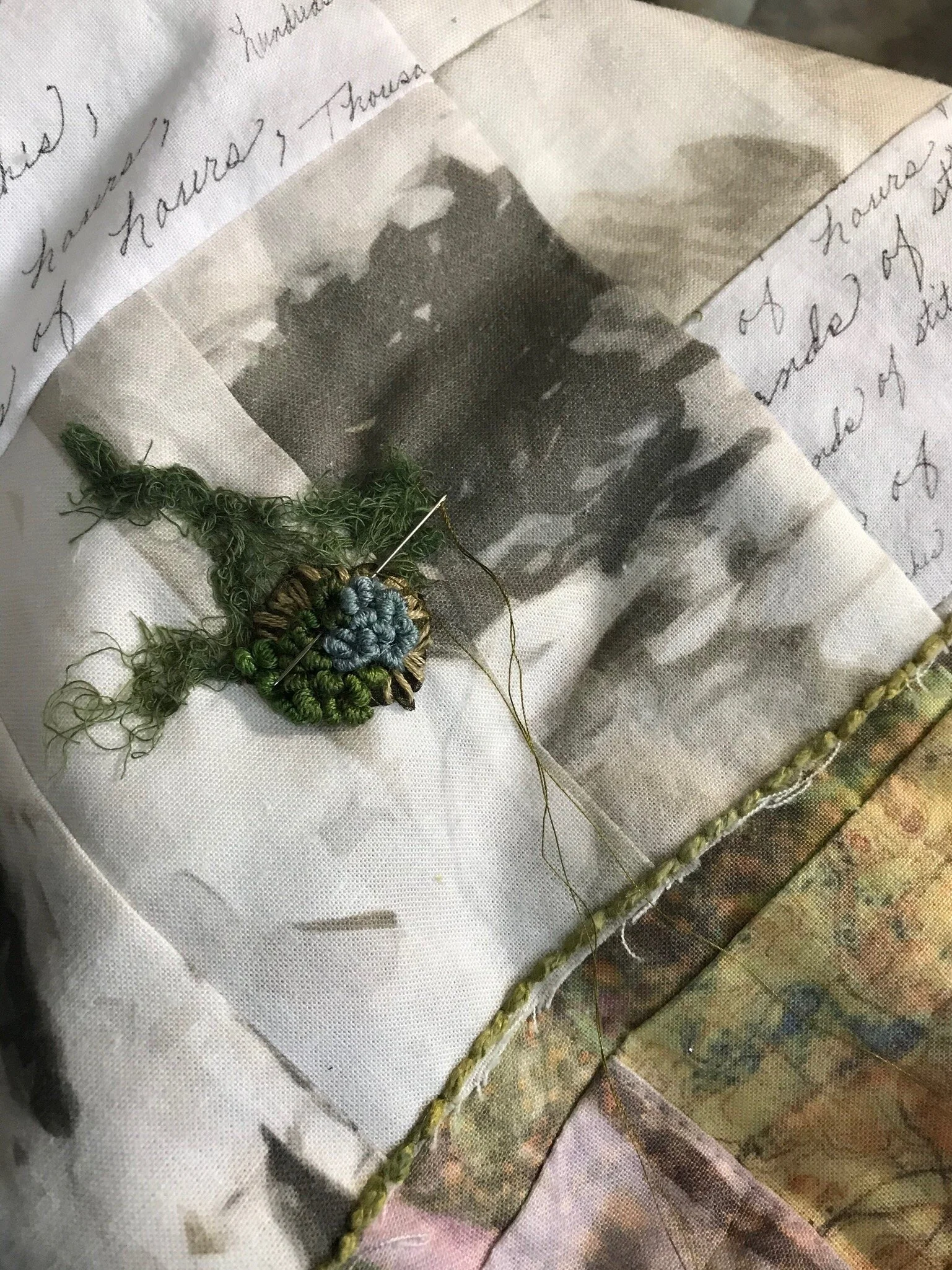 Stitching the embroidery to the quilt.