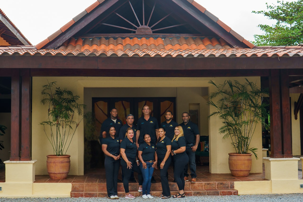 staff pose at the villa entrance