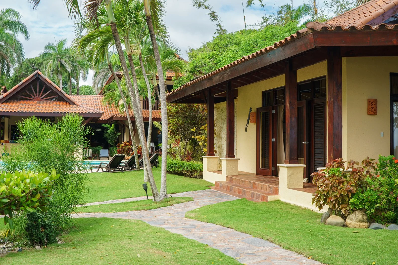 One of the accommodations at the Villa with the main house and pool in the background.