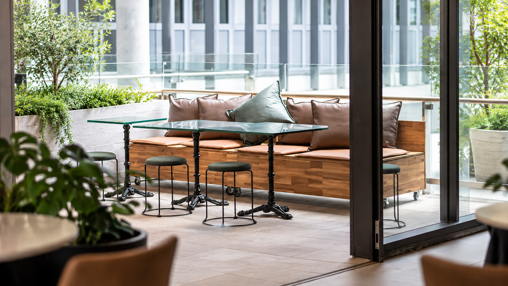Modern Café Terrace with Lush Greenery.png
